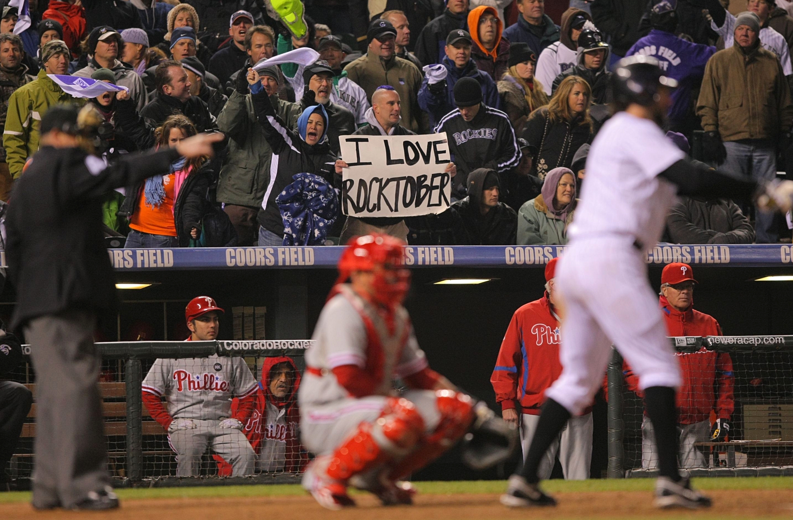 DENVER - OCTOBER 11:  Fans of the Colorado Rockies cheer for their team and hold up a sign which reads 'I Love Rocktober' against the Philadelphia Phillies in Game Three of the NLDS during the 2009 MLB Playoffs at Coors Field on October 11, 2009 in Denver