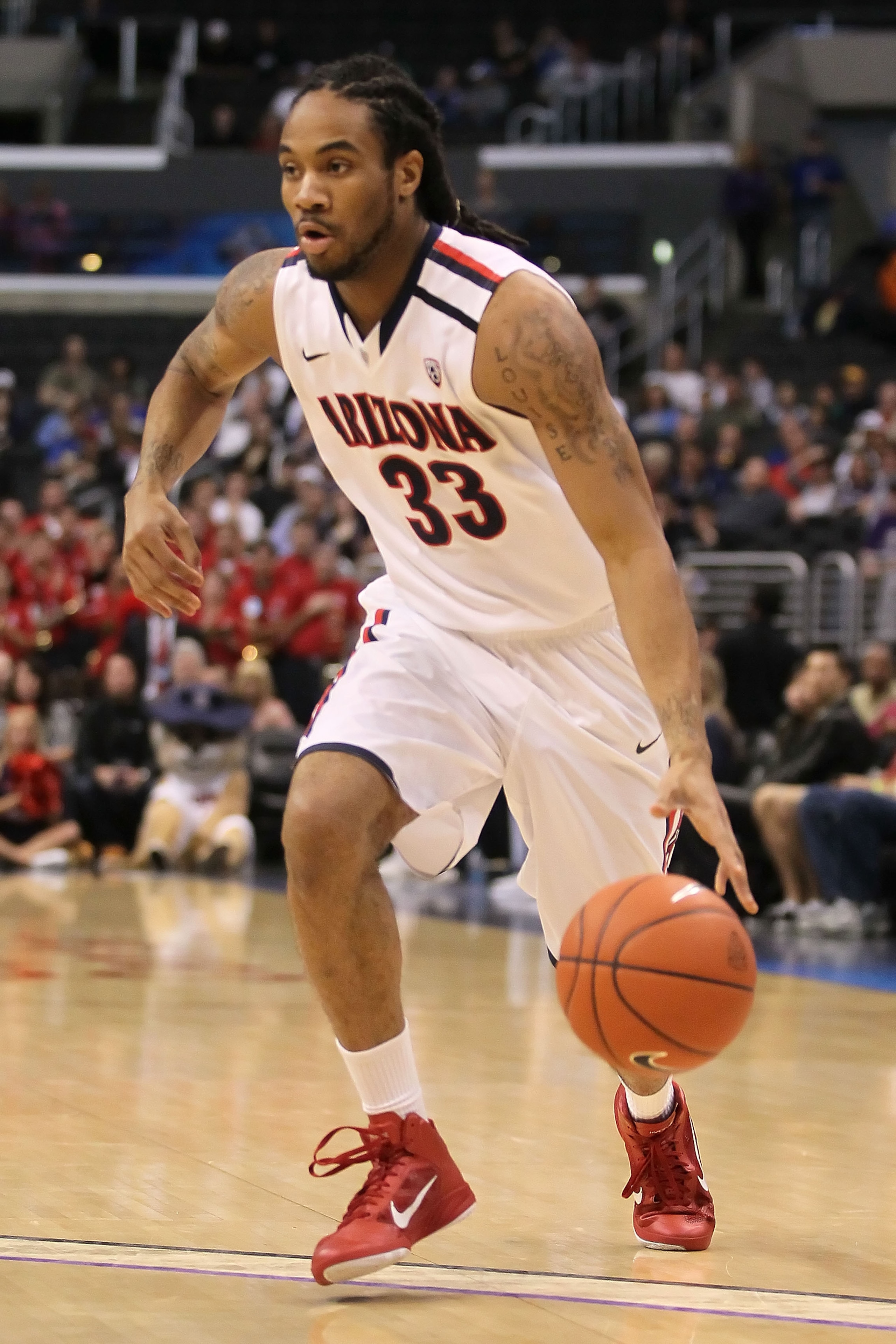 LOS ANGELES, CA - MARCH 12:  Jesse Perry #33 of the Arizona Wildcats moves the ball while taking on the Washington Huskies in the championship game of the 2011 Pacific Life Pac-10 Men's Basketball Tournament at Staples Center on March 12, 2011 in Los Ange