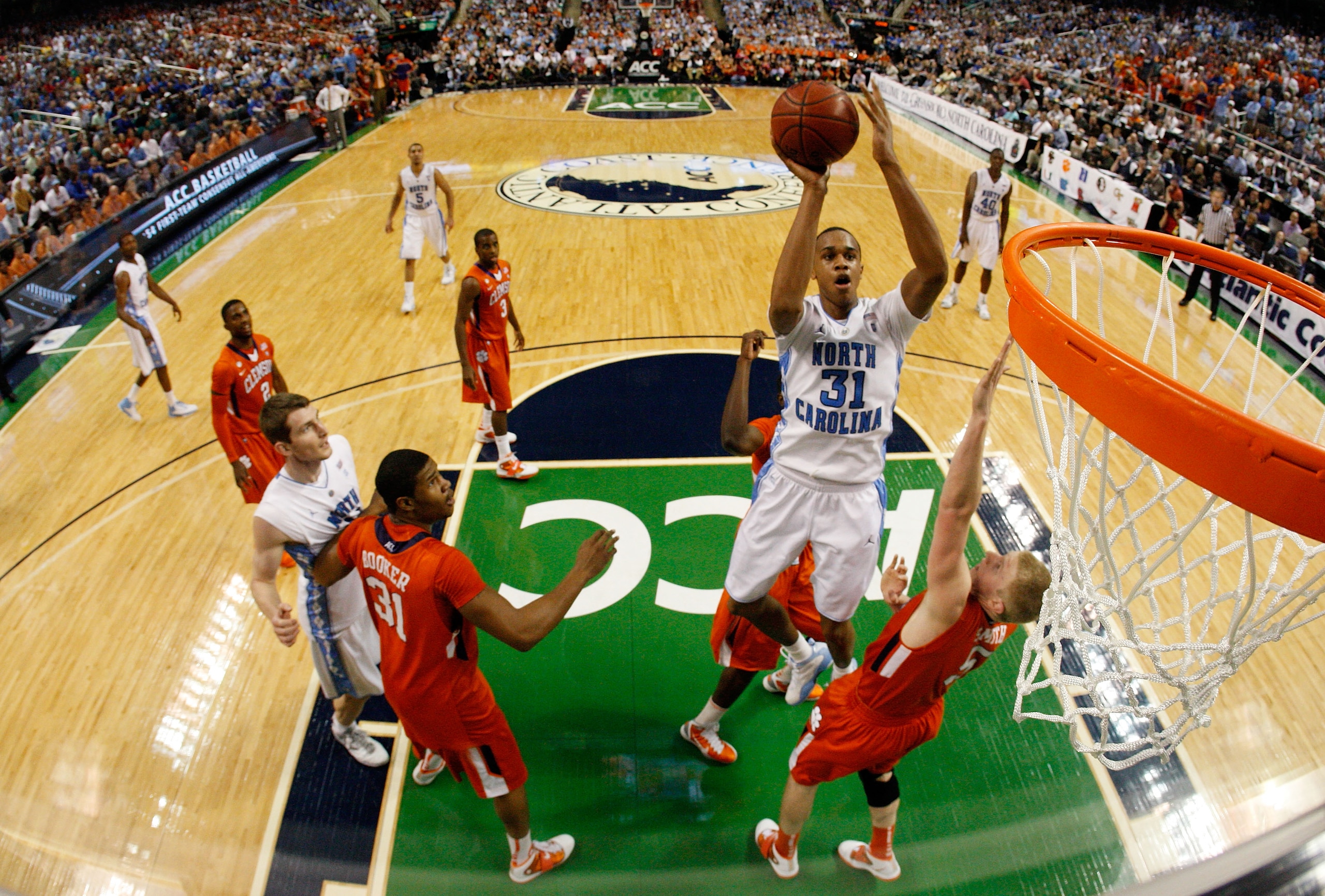 GREENSBORO, NC - MARCH 12: John Henson #31 of the North Carolina Tar Heels shoots against Tanner Smith #5 of the Clemson Tigers in the semifinals of the 2011 ACC men's basketball tournament at the Greensboro Coliseum on March 12, 2011 in Greensboro, Nort GREENSBORO, NC - MARCH 12: John Henson #31 of the North Carolina Tar Heels shoots against Tanner Smith #5 of the Clemson Tigers in the semifinals of the 2011 ACC men's basketball tournament at the Greensboro Coliseum on March 12, 2011 in Greensboro, Nort
