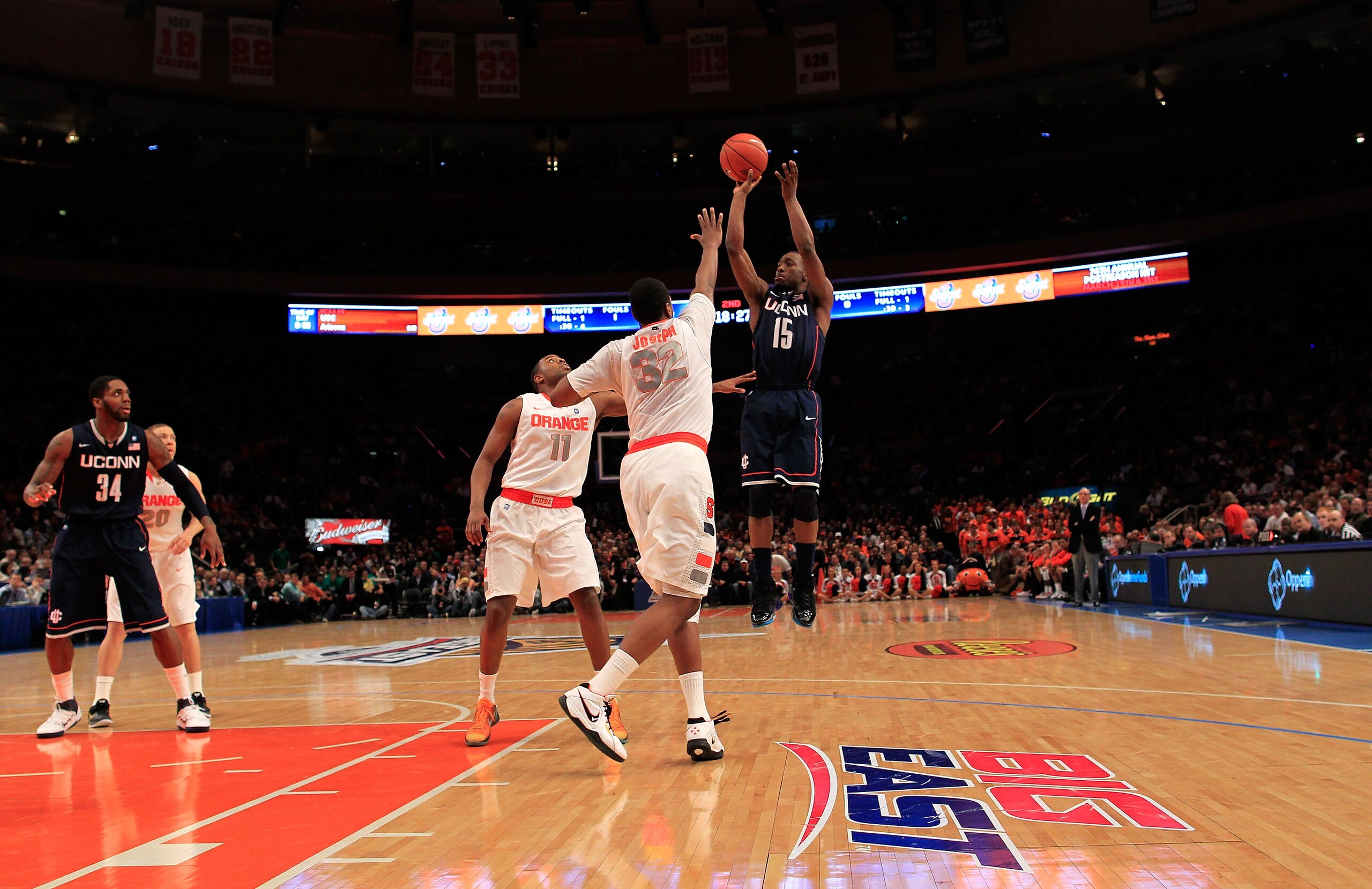 NEW YORK, NY - MARCH 11: Kemba Walker #15 of the Connecticut Huskies shoots over Kris Joseph #32 of the Syracuse Orange during the semifinals of the 2011 Big East Men's Basketball Tournament presented by American Eagle Outfitters at Madison Square Garden