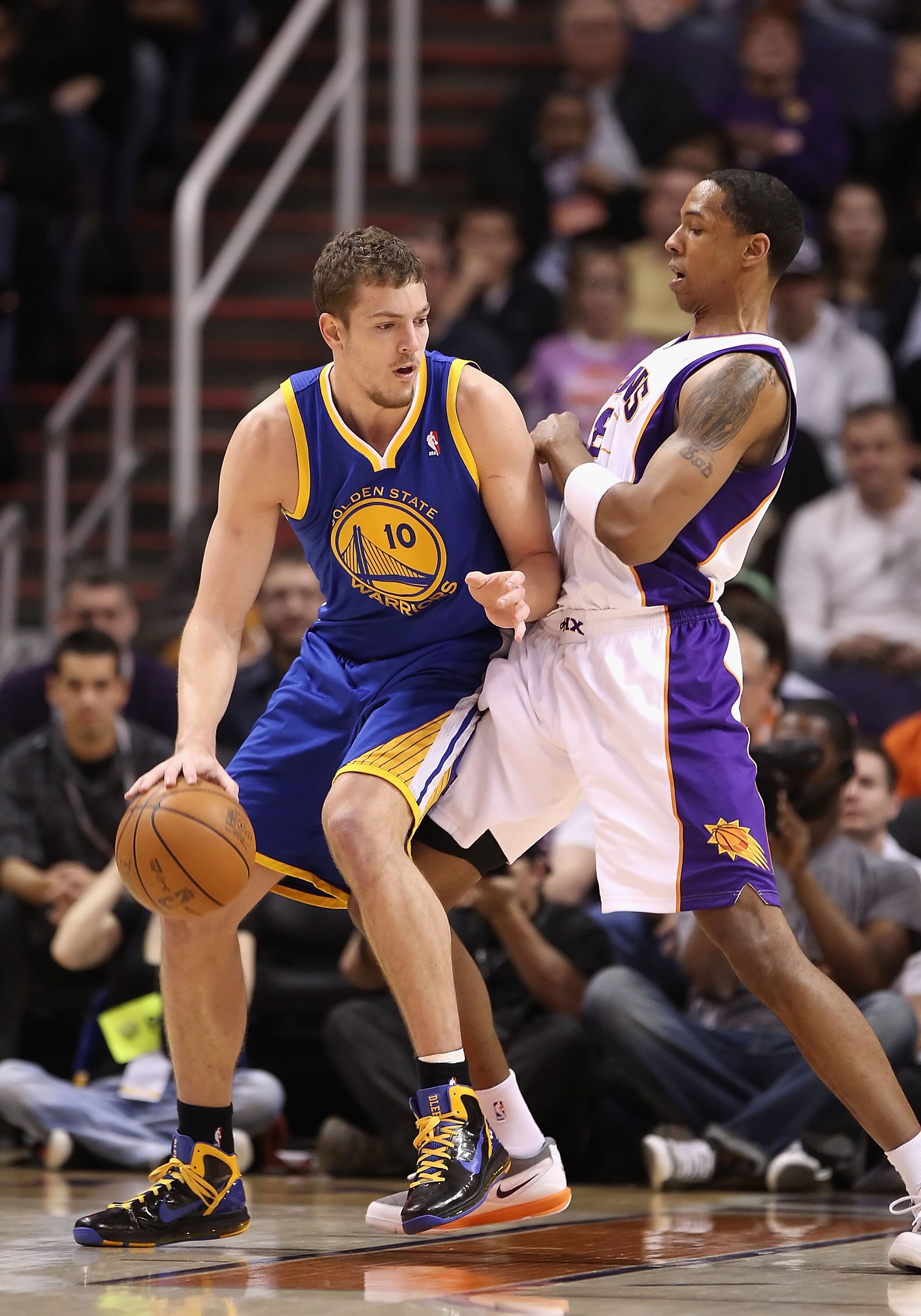 PHOENIX, AZ - FEBRUARY 10:  David Lee #10 of the Golden State Warriors handles the ball during the NBA game against the Phoenix Suns at US Airways Center on February 10, 2011 in Phoenix, Arizona.  The Suns defeated the Warriors 112-88.  NOTE TO USER: User