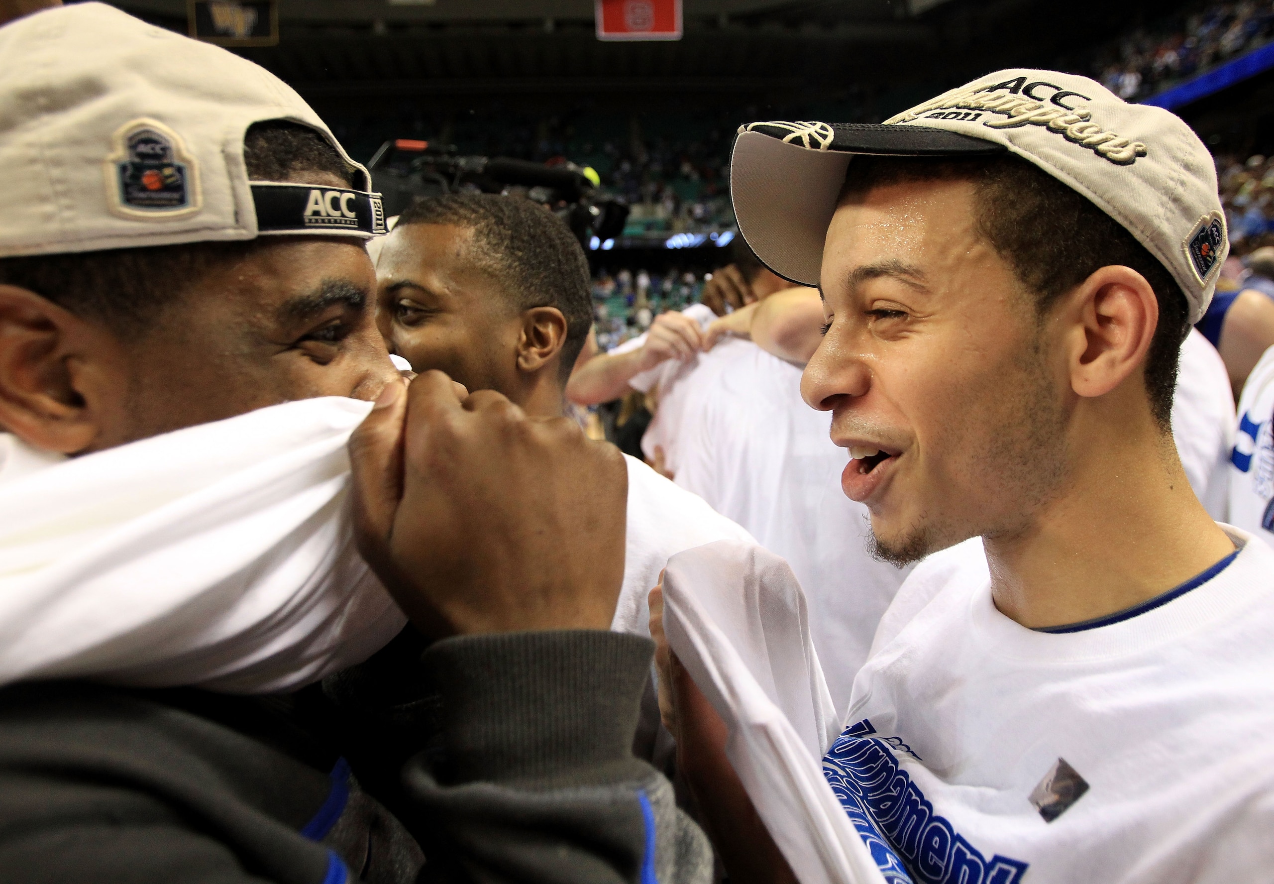 GREENSBORO, NC - MARCH 13:  Kyrie Irving #1 and Tyler Thornton #3 of the Duke Blue Devils celebrate their 75-58 victory over the North Carolina Tar Heels in the championship game of the 2011 ACC men's basketball tournament at the Greensboro Coliseum on Ma