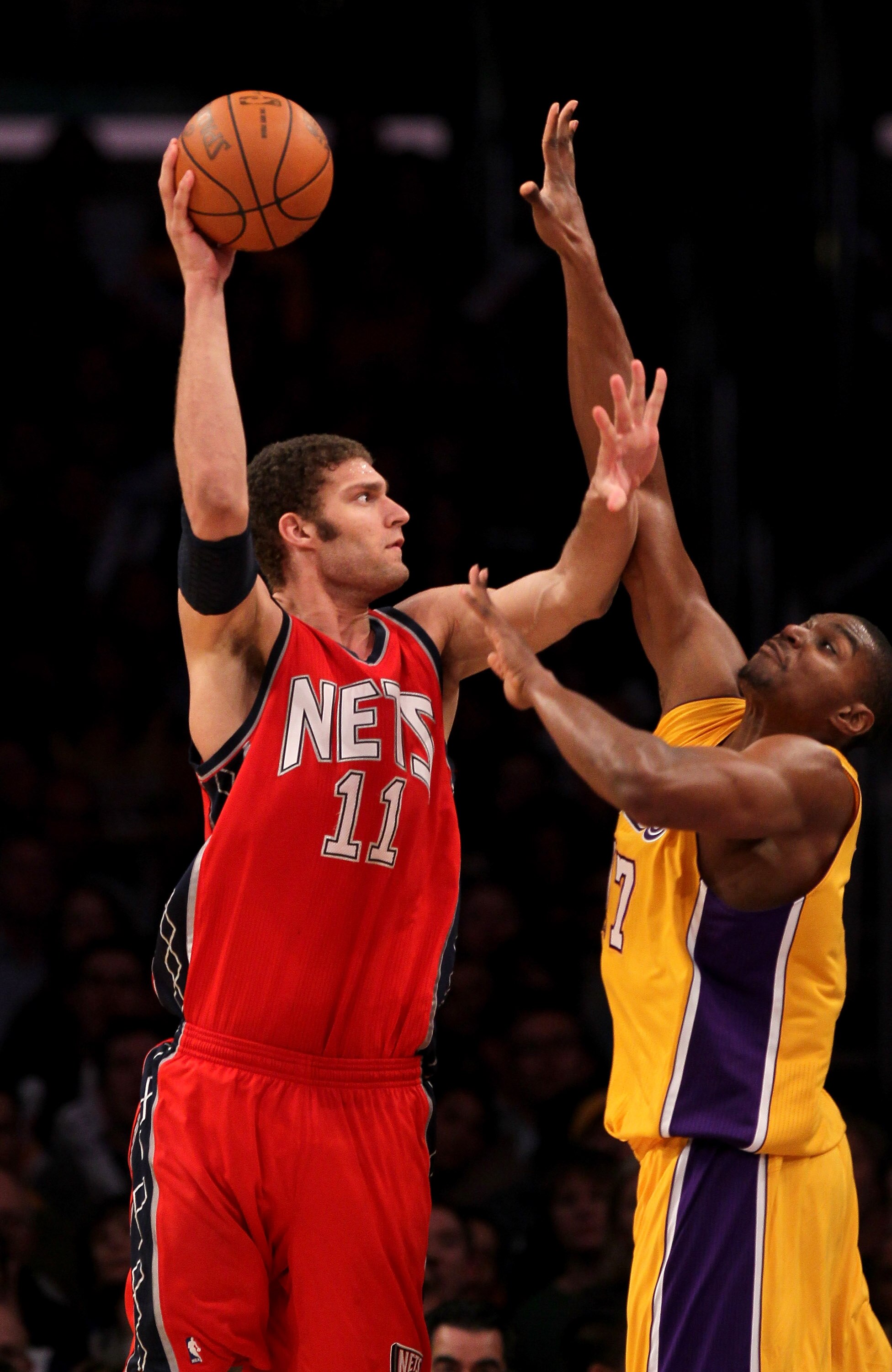 LOS ANGELES, CA - JANUARY 14: Brook Lopez #11 of the New Jersey Nets shoots over Andrew Bynum #17 of the Los Angeles Lakers at Staples Center on January 14, 2011 in Los Angeles, California. The Lakers won 100-88.  NOTE TO USER: User expressly acknowledges