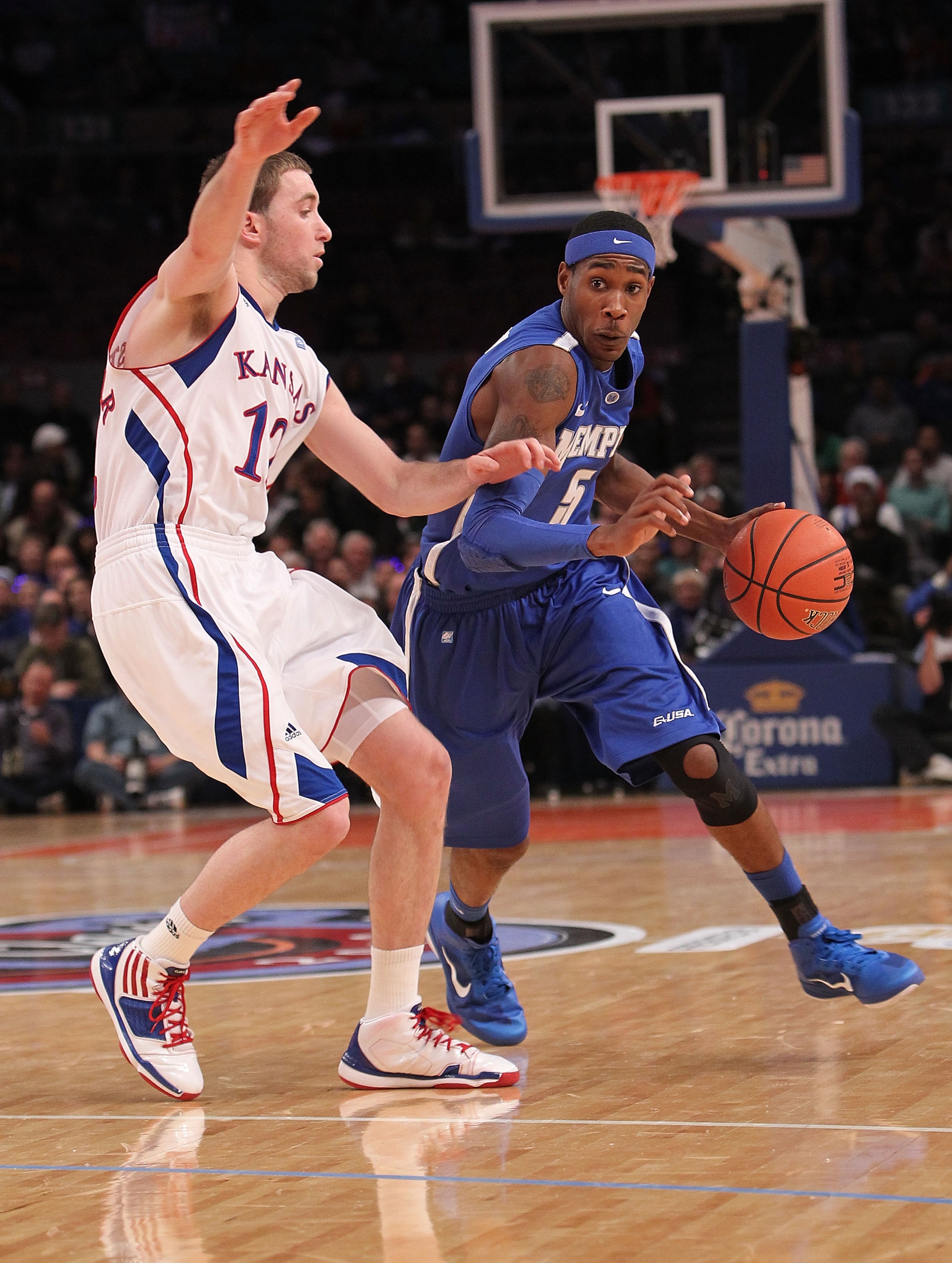 NEW YORK, NY - DECEMBER 07:  Will Barton #5 of the Memphis Tigers drives to the basket against Brady Morningstar #12 of the Kansas Jayhawks during their game at the Jimmy V Classic at Madison Square Garden on December 7, 2010 in New York City.  (Photo by