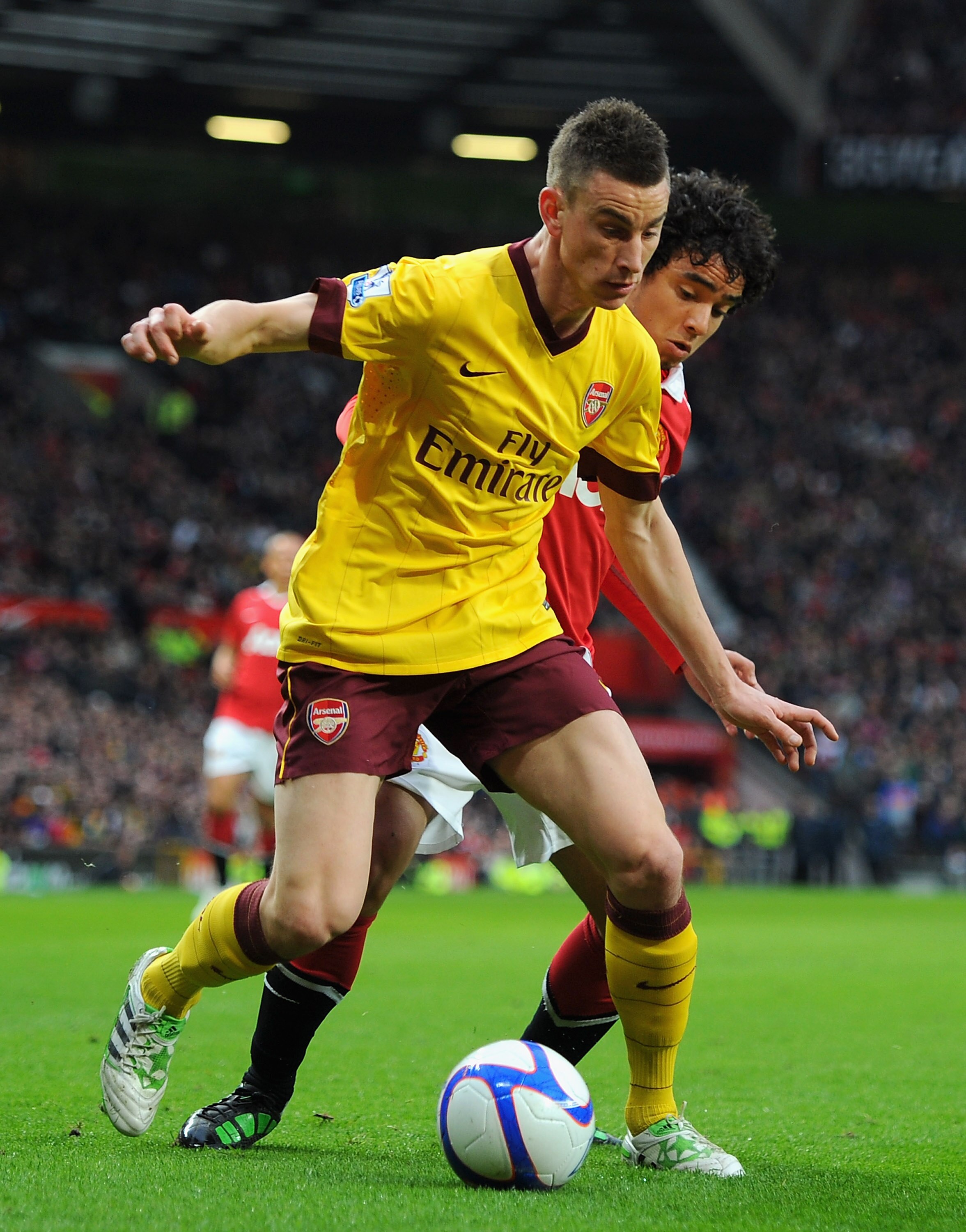 MANCHESTER, ENGLAND - MARCH 12:  Laurent Koscielny of Arsenal and Rafael Da Silva of Manchester United battle for the ball during the FA Cup sponsored by E.On Sixth Round match between Manchester United and Arsenal at Old Trafford on March 12, 2011 in Man
