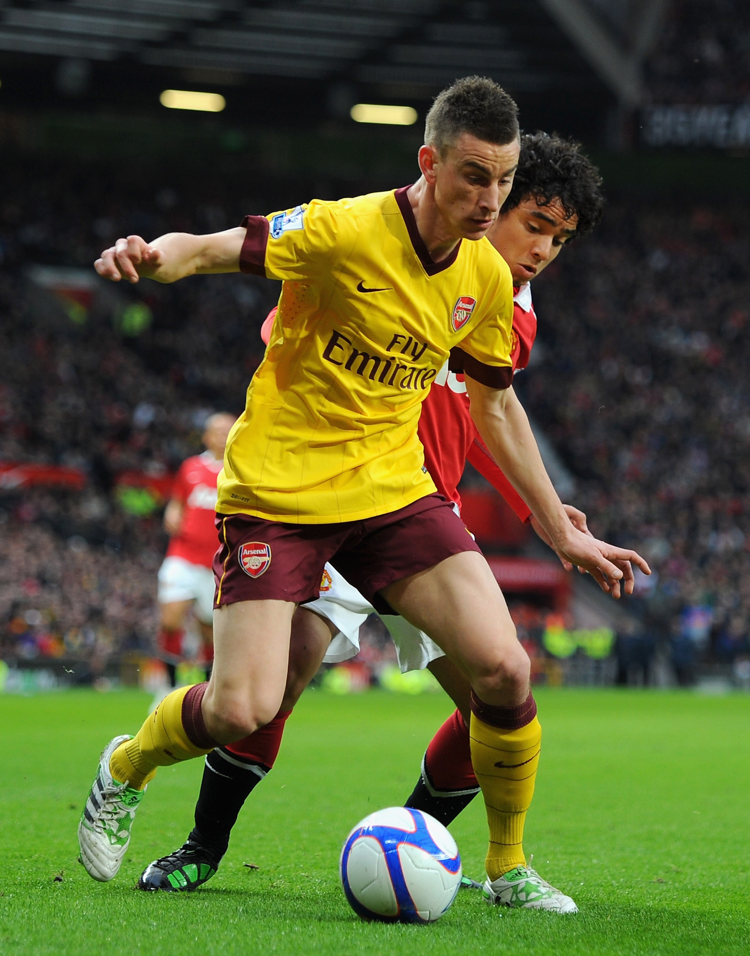 MANCHESTER, ENGLAND - MARCH 12:  Laurent Koscielny of Arsenal and Rafael Da Silva of Manchester United battle for the ball during the FA Cup sponsored by E.On Sixth Round match between Manchester United and Arsenal at Old Trafford on March 12, 2011 in Man
