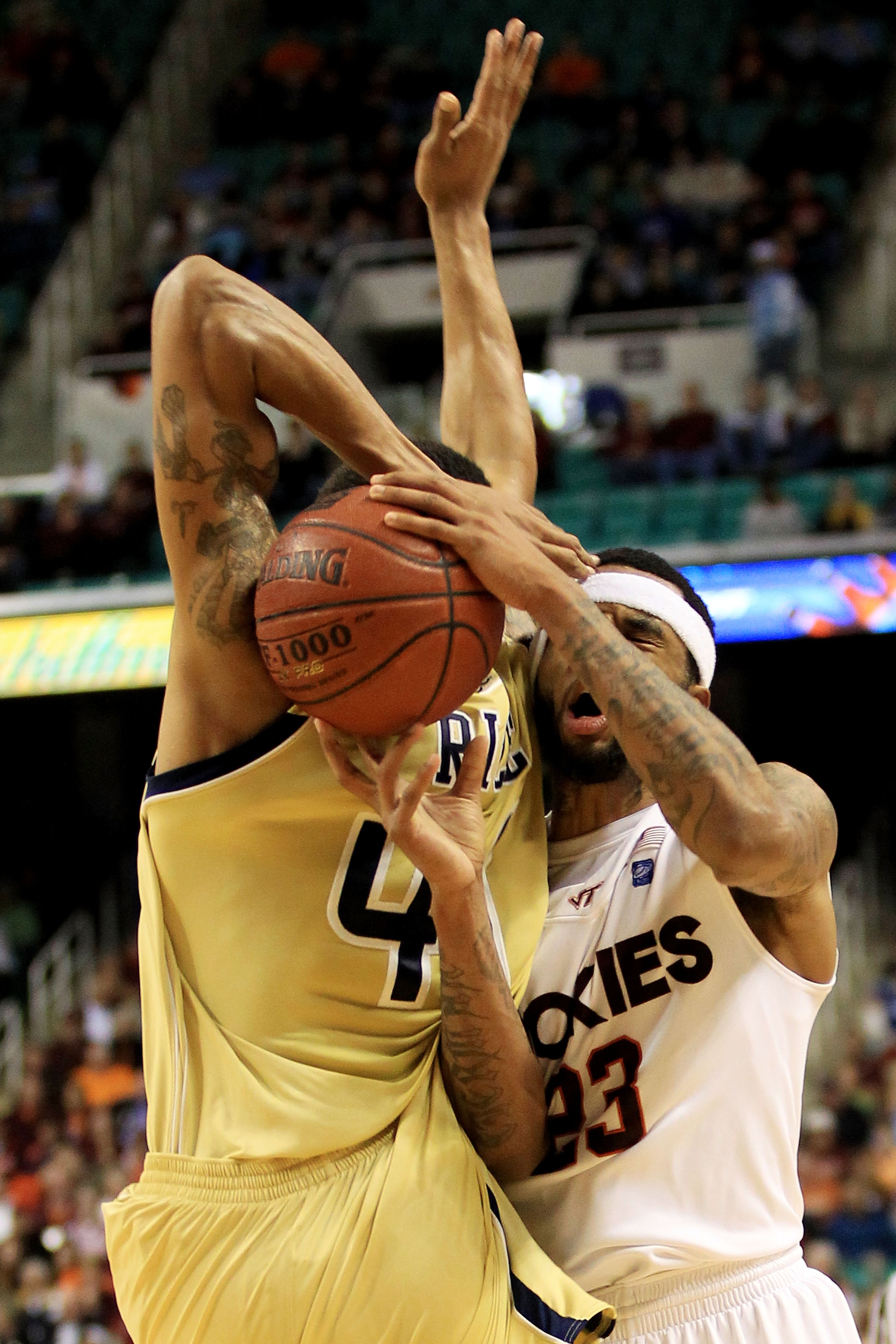 GREENSBORO, NC - MARCH 10:  Glen Rice Jr. #41 of the Georgia Tech Yellow Jackets and Malcolm Delaney #23 of the Virginia Tech Hokies battle for possession of the ball during the first half of the game in the first round of the 2011 ACC men's basketball to