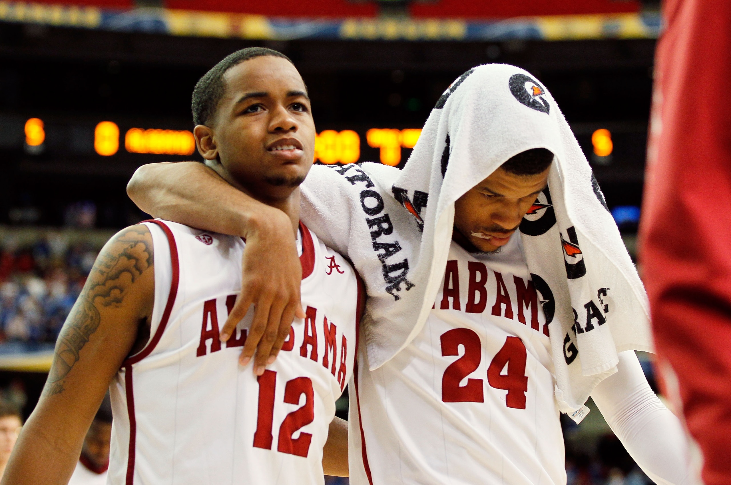 ATLANTA, GA - MARCH 12:  Trevor Releford #12 and Charvez Davis #24 of the Alabama Crimson Tide walk off of the court dejected after loosing to the Kentucky Wildcats 58 to 72 during the semifinals of the SEC Men's Basketball Tournament at Georgia Dome on M