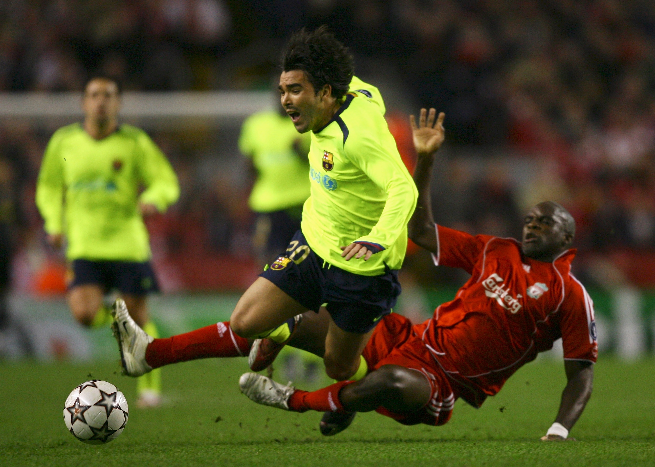 LIVERPOOL, UNITED KINGDOM - MARCH 06:  Deco of Barcelona is brought down by Momo Sissoko of Liverpool during the UEFA Champions League round of sixteen, second leg match between Liverpool and Barcelona at Anfield on March 6, 2007 in Liverpool, England.  (