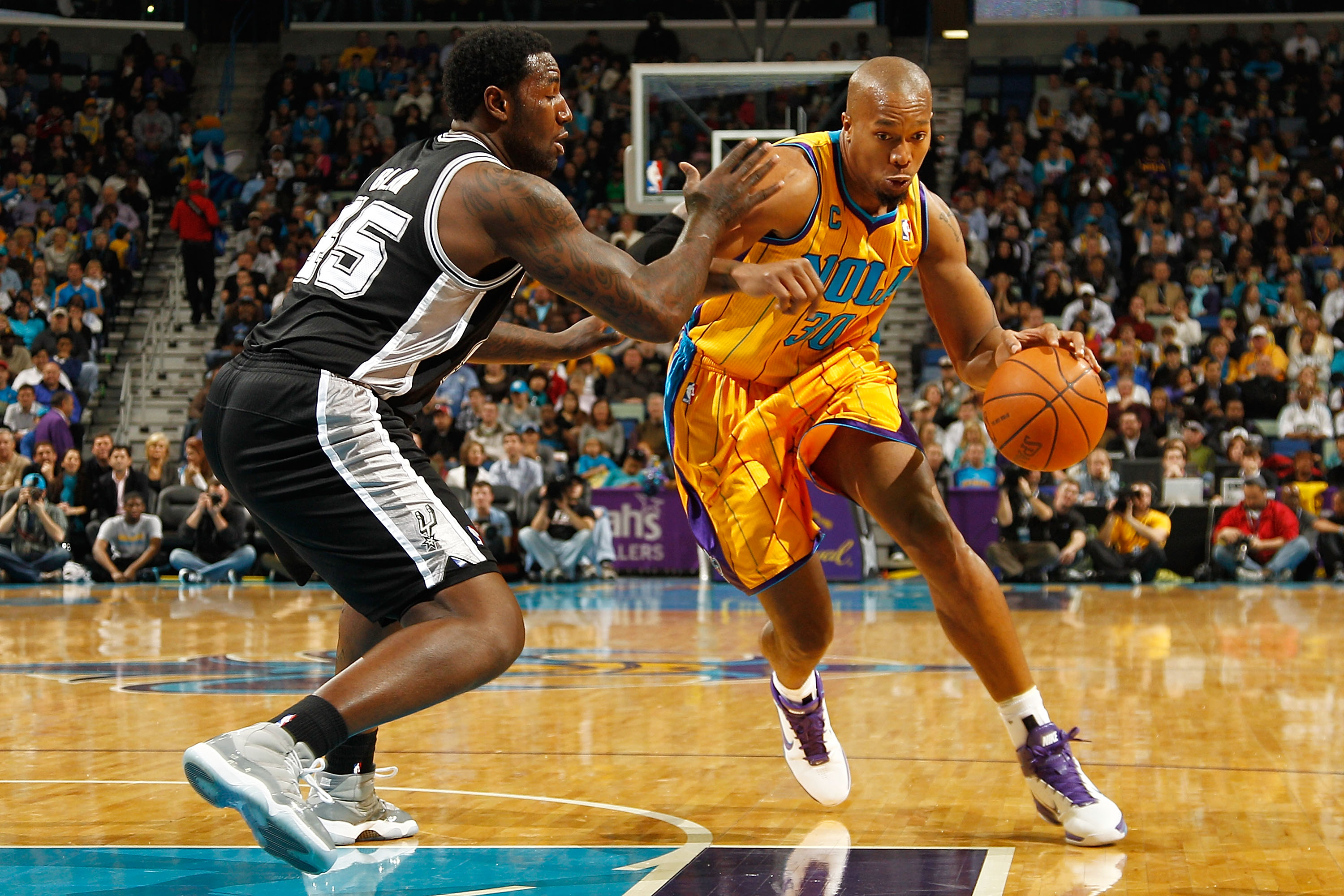 NEW ORLEANS, LA - JANUARY 22:  David West #30 of the New Orleans Hornets drives the ball around DeJuan Blair #45 of the San Antonio Spurs at the New Orleans Arena on January 22, 2011 in New Orleans, Louisiana.  NOTE TO USER: User expressly acknowledges an