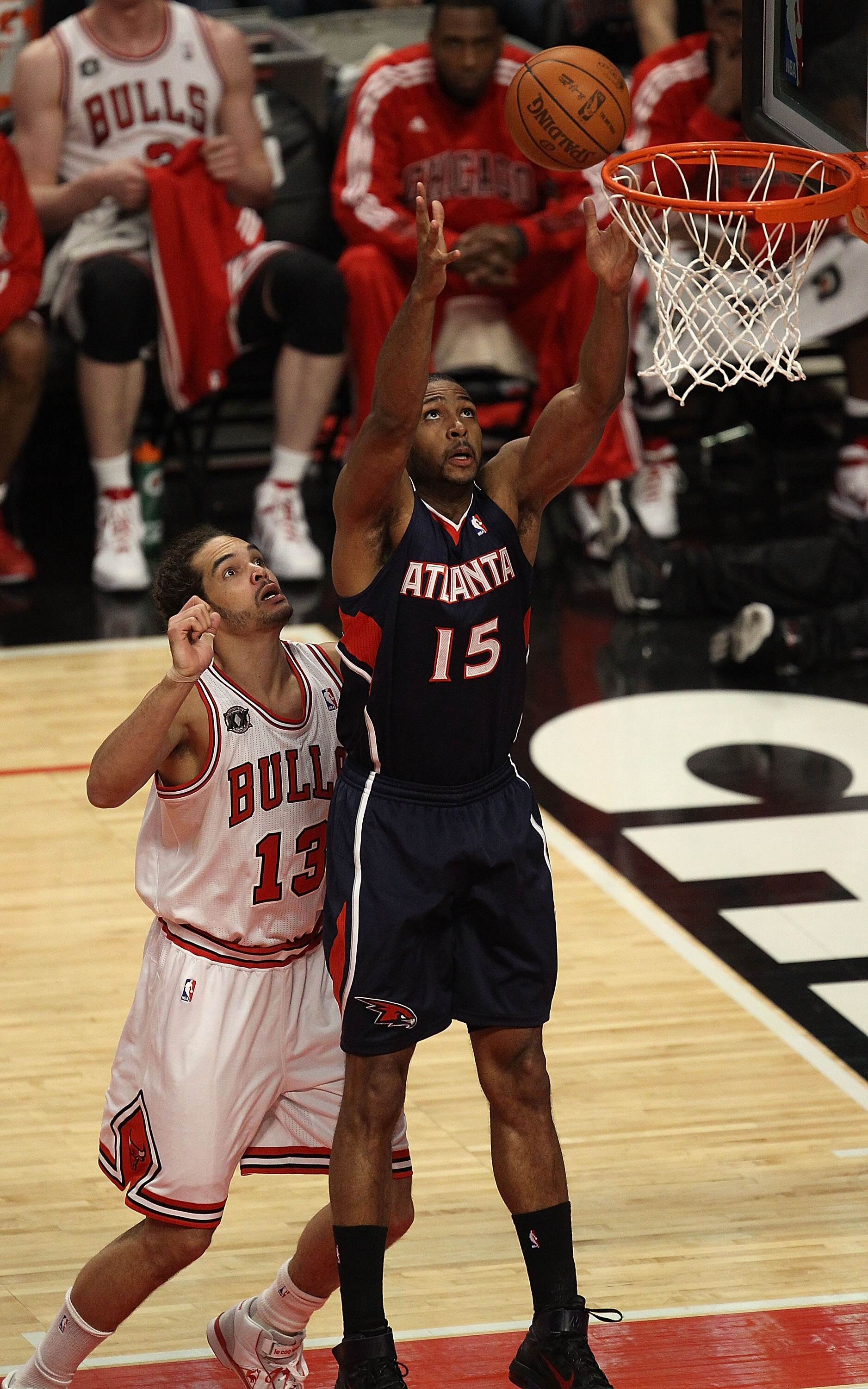 CHICAGO, IL - MARCH 11: Al Horford #15 of the Atlanta Hawks grabs a rebound in front of Jaokim Noah #13 of the Chicago Bulls at the United Center on March 11, 2011 in Chicago, Illinois. NOTE TO USER: User expressly acknowledges and agrees that, by downloa