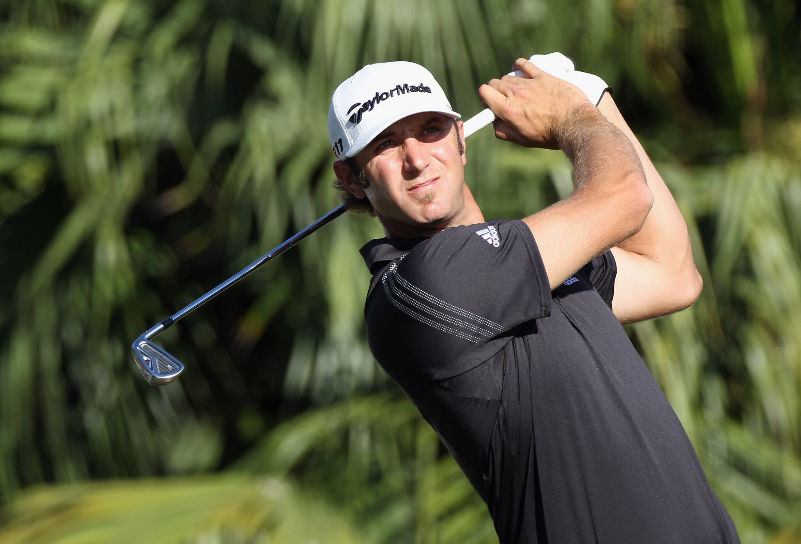 DORAL, FL - MARCH 13:  Dustin Johnson hits his tee shot on the 13th hole during the final round of the 2011 WGC- Cadillac Championship at the TPC Blue Monster at the Doral Golf Resort and Spa on March 13, 2011 in Doral, Florida.  (Photo by Sam Greenwood/G
