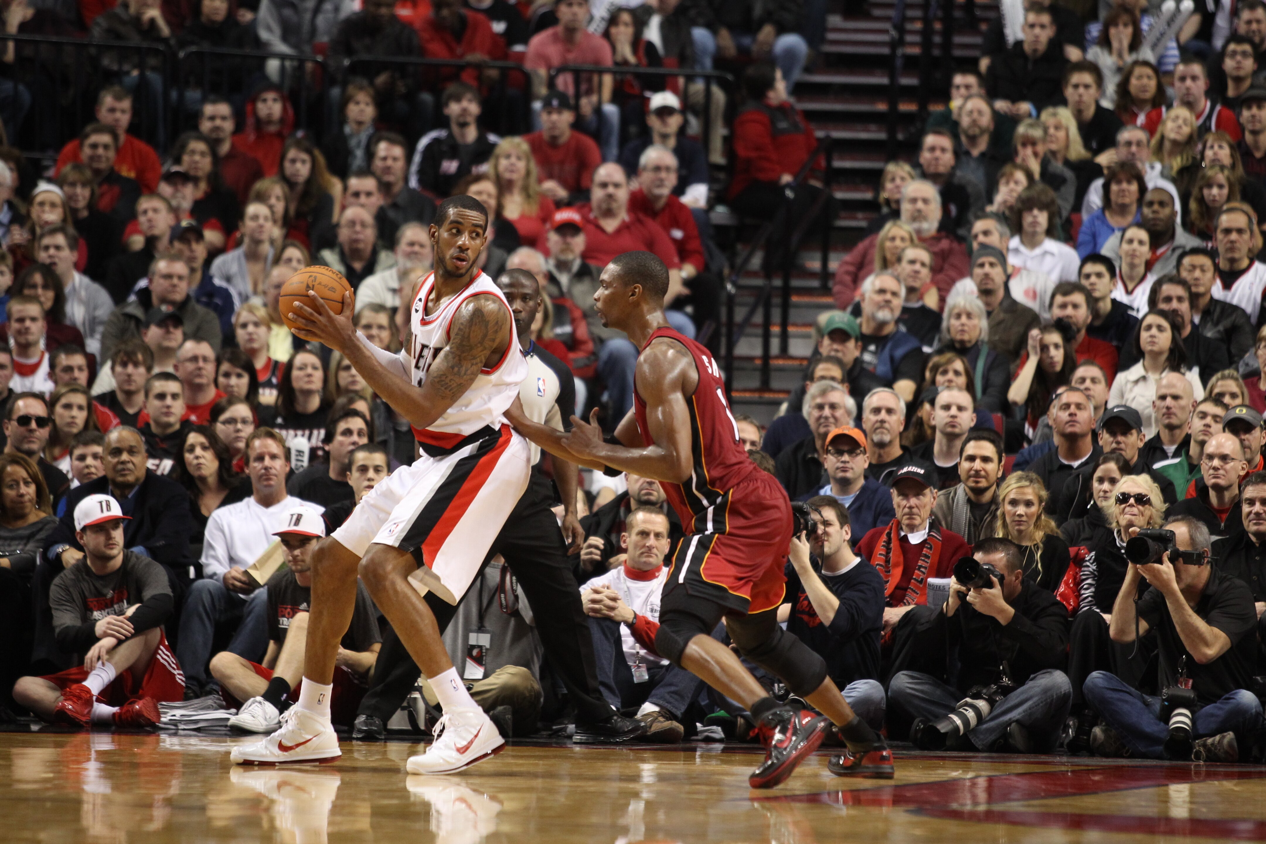 PORTLAND, OR - JANUARY 09: LaMarcus Aldridge #12 of the Portland Trail Blazers posts up against Chris Bosh #1 of the Miami Heat during a game on January 9, 2011 at the Rose Garden Arena in Portland, Oregon. NOTE TO USER: User expressly acknowledges and ag