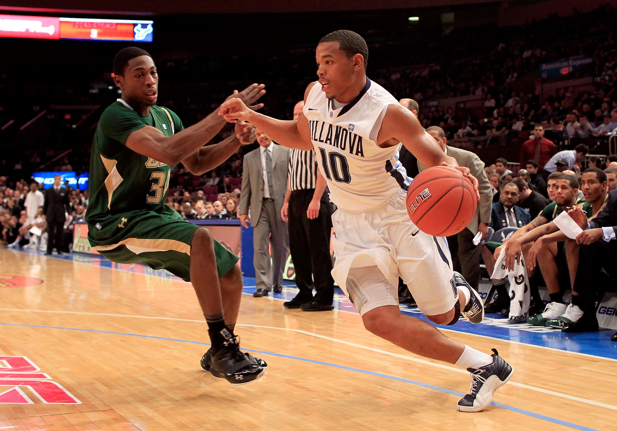 NEW YORK, NY - MARCH 08:  Corey Fisher #10 of the Villanova Wildcats dribbles toward the basket against Hugh Robertson #34 of the South Florida Bulls during the first round of the 2011 Big East Men's Basketball Tournament presented by American Eagle Outfi