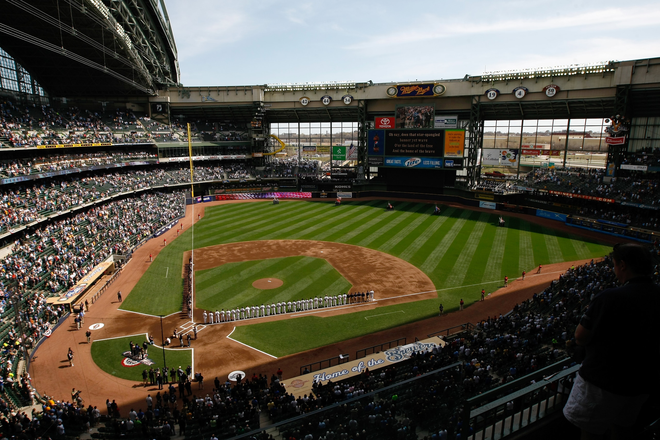 MILWAUKEE, WI - APRIL 05: The Colorado Rockies and Milwaukee Brewers line up on the base lines after introductions during the National Anthem prior to the game between the Colorado Rockies against the Milwaukee Brewers at the Miller Park on April 05, 2010