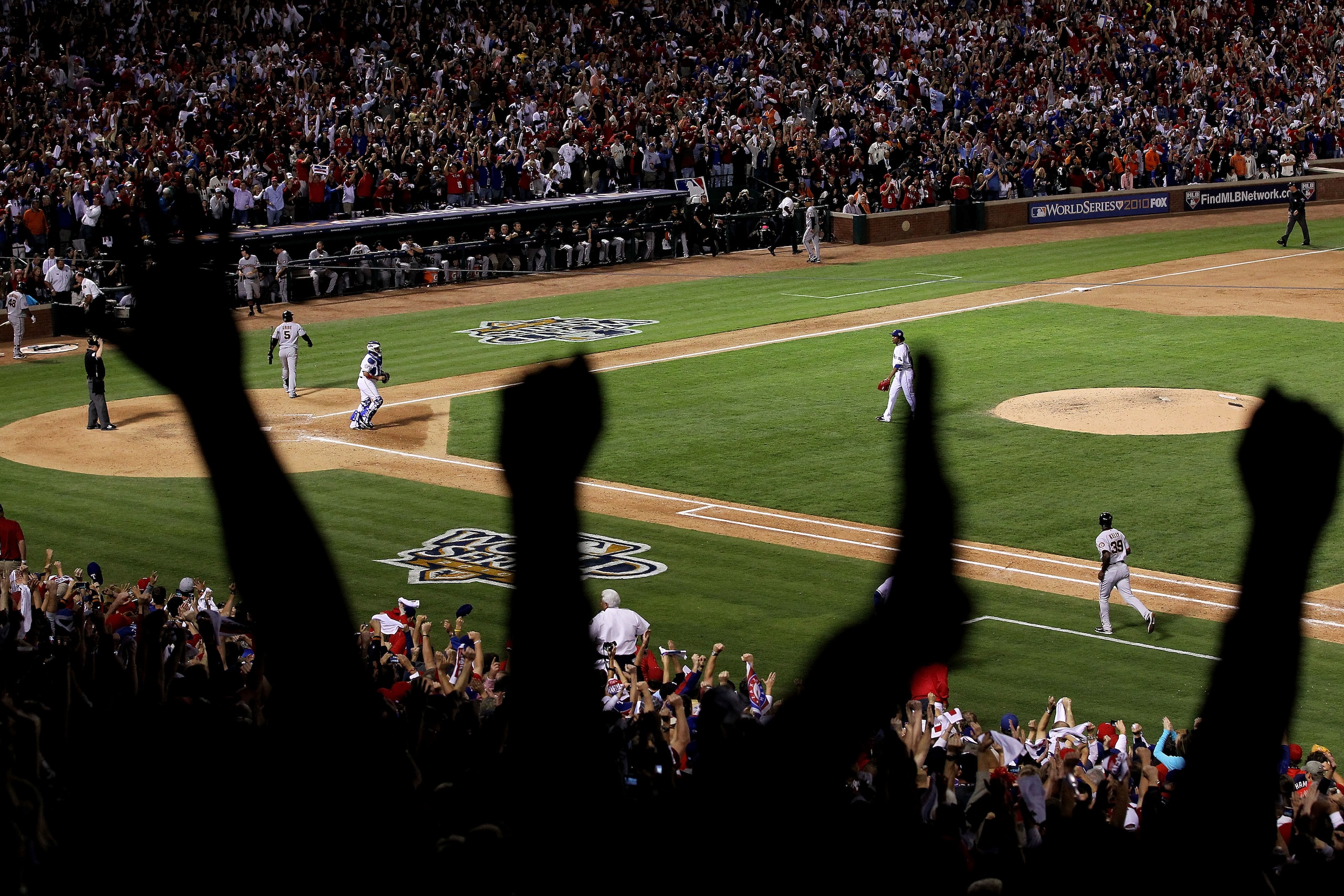 ARLINGTON, TX - OCTOBER 30:  Fans celebrate as closing pitcher Neftali Feliz #30 of the Texas Rangers records the final out of their 4-2 win against the San Francisco Giants in Game Three of the 2010 MLB World Series at Rangers Ballpark in Arlington on Oc