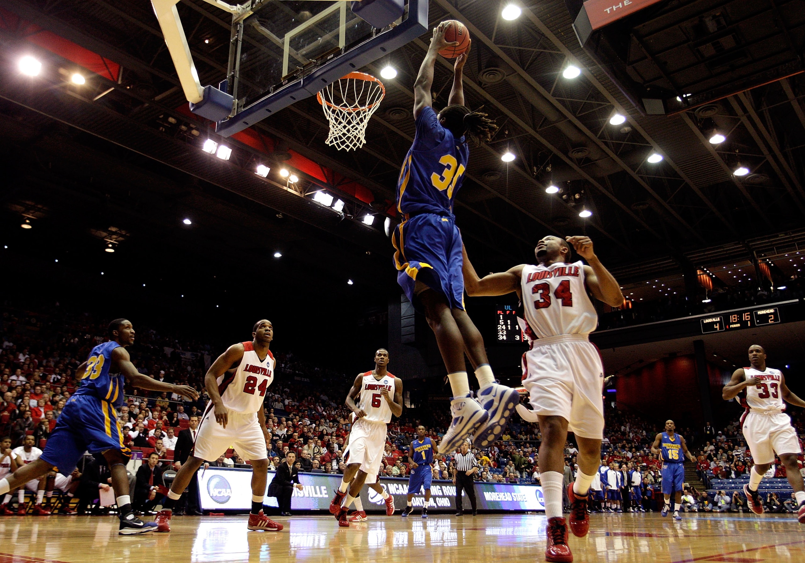DAYTON, OH - MARCH 20: Kenneth Faried #35 of the Morehead State Eagles drives to the hoop against Jerry Smith #34 of the Louisville Cardinals during the first round of the NCAA Division I Men's Basketball Tournament at the University of Dayton Arena on Ma