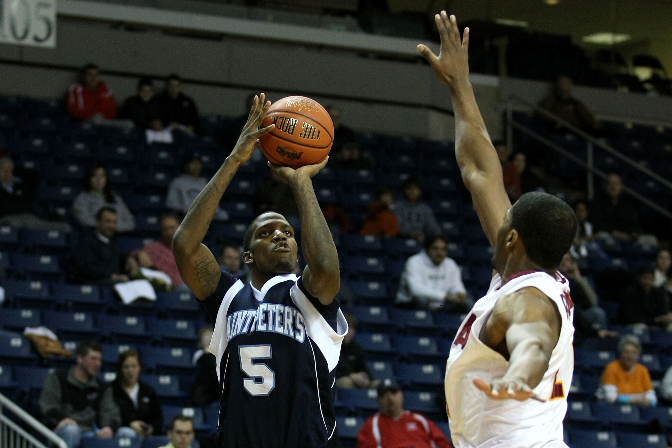 BRIDGEPORT, CT - MARCH 07:  Jeron Belin #5 of the St. Peter's Peacocks attempts a shot against the Iona Gaels during the final of the MAAC men's conference basketball tournment at Webster Bank Arena at Harbor Yard on March 7, 2011 in Bridgeport, Connectic