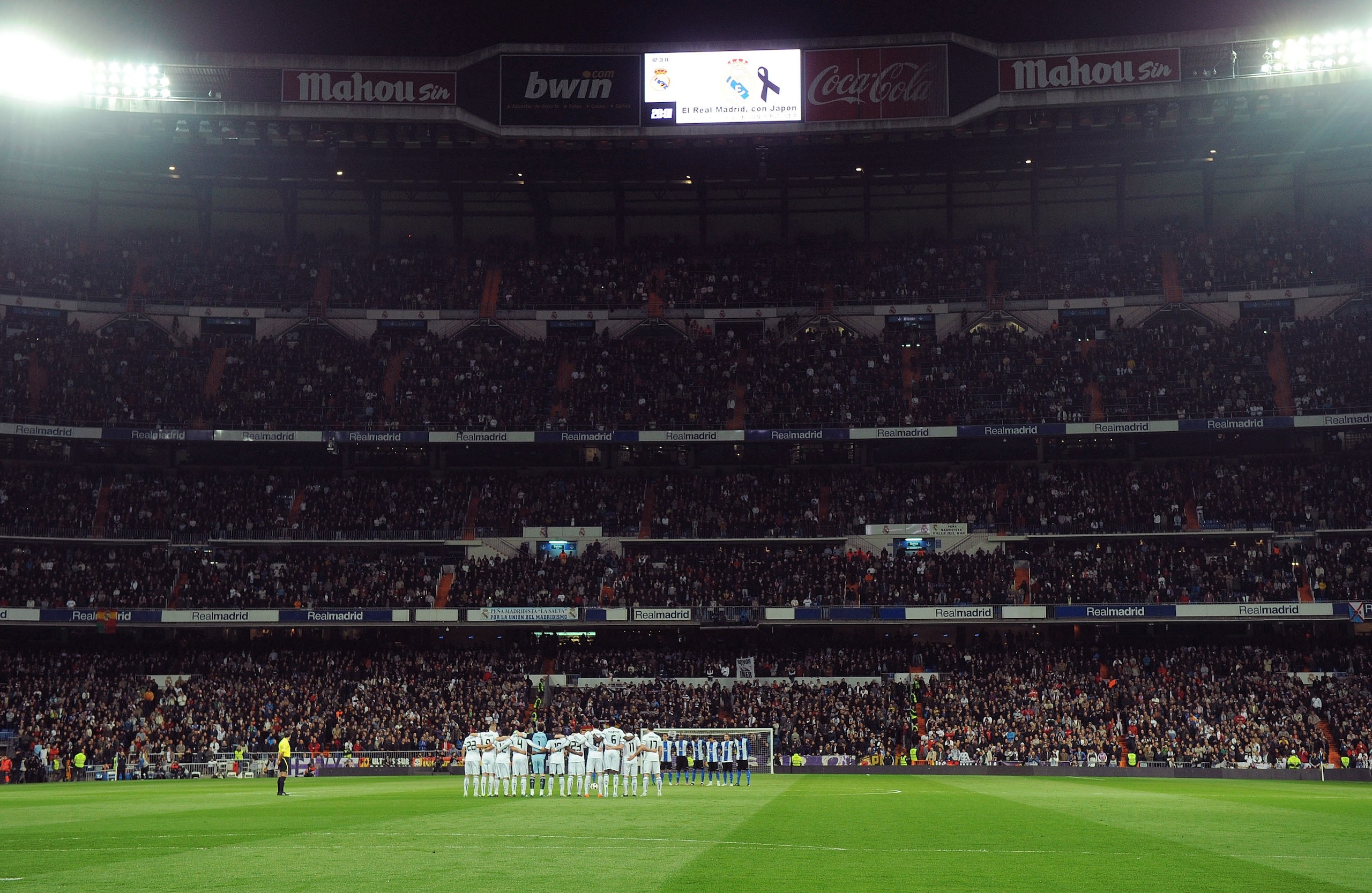 MADRID, SPAIN - MARCH 12:  Real Madrid and Hercules CF players hold a minute of silence in respect for the victims of the recent earthquake in Japan before the La Liga match between Real Madrid and Hercules CF at Estadio Santiago Bernabeu on March 12, 201