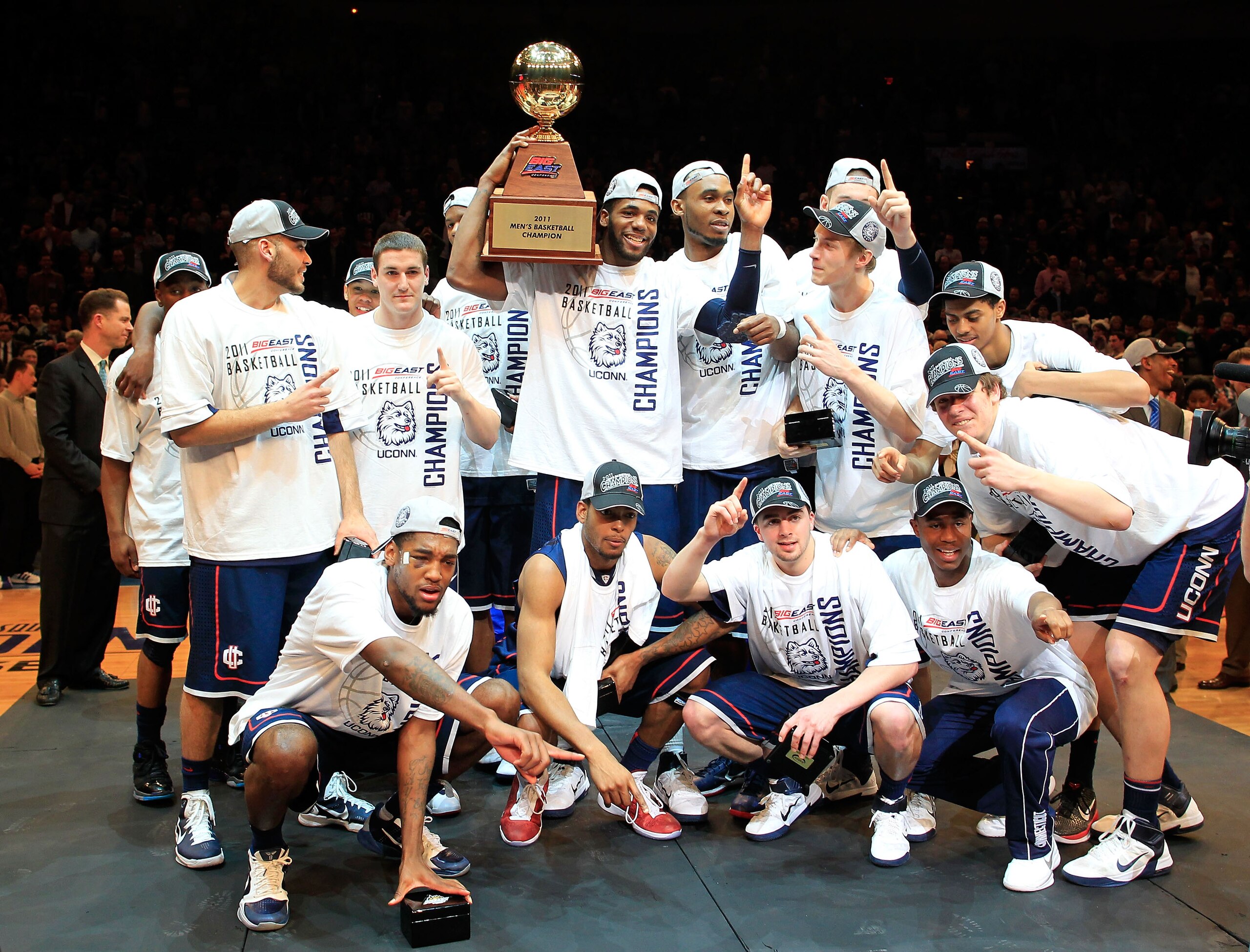 NEW YORK, NY - MARCH 12:  The Connecticut Huskies celebrate with their trophy after defeating the Louisville Cardinals during the championship of the 2011 Big East Men's Basketball Tournament presented by American Eagle Outfitters at Madison Square Garden