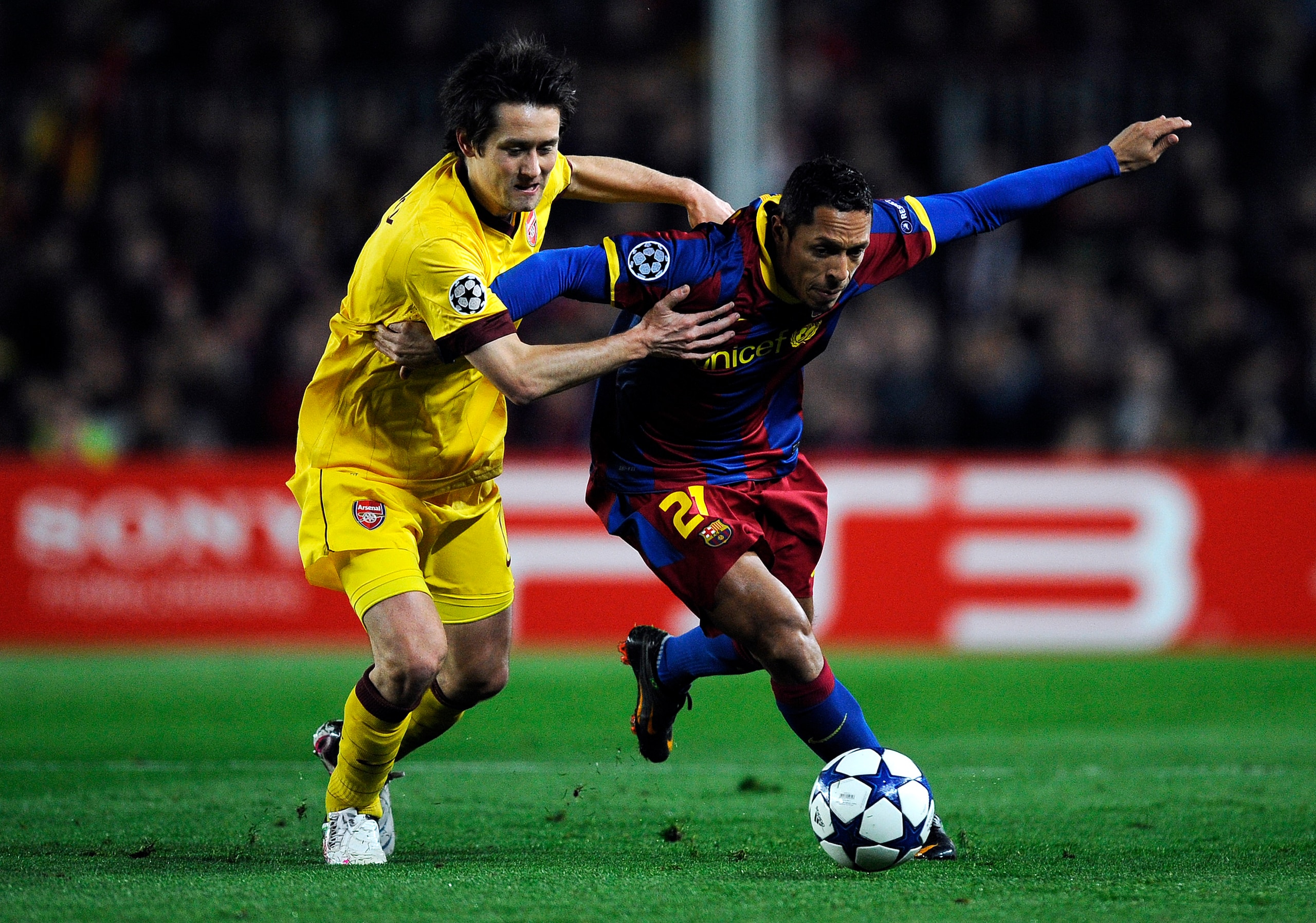 BARCELONA, SPAIN - MARCH 08:  Adriano of FC Barcelona (R) duels for the ball against Tomas Rosicky of Arsenal during the UEFA Champions League round of 16 second leg match between Barcelona and Arsenal at the Camp Nou stadium on March 8, 2011 in Barcelona