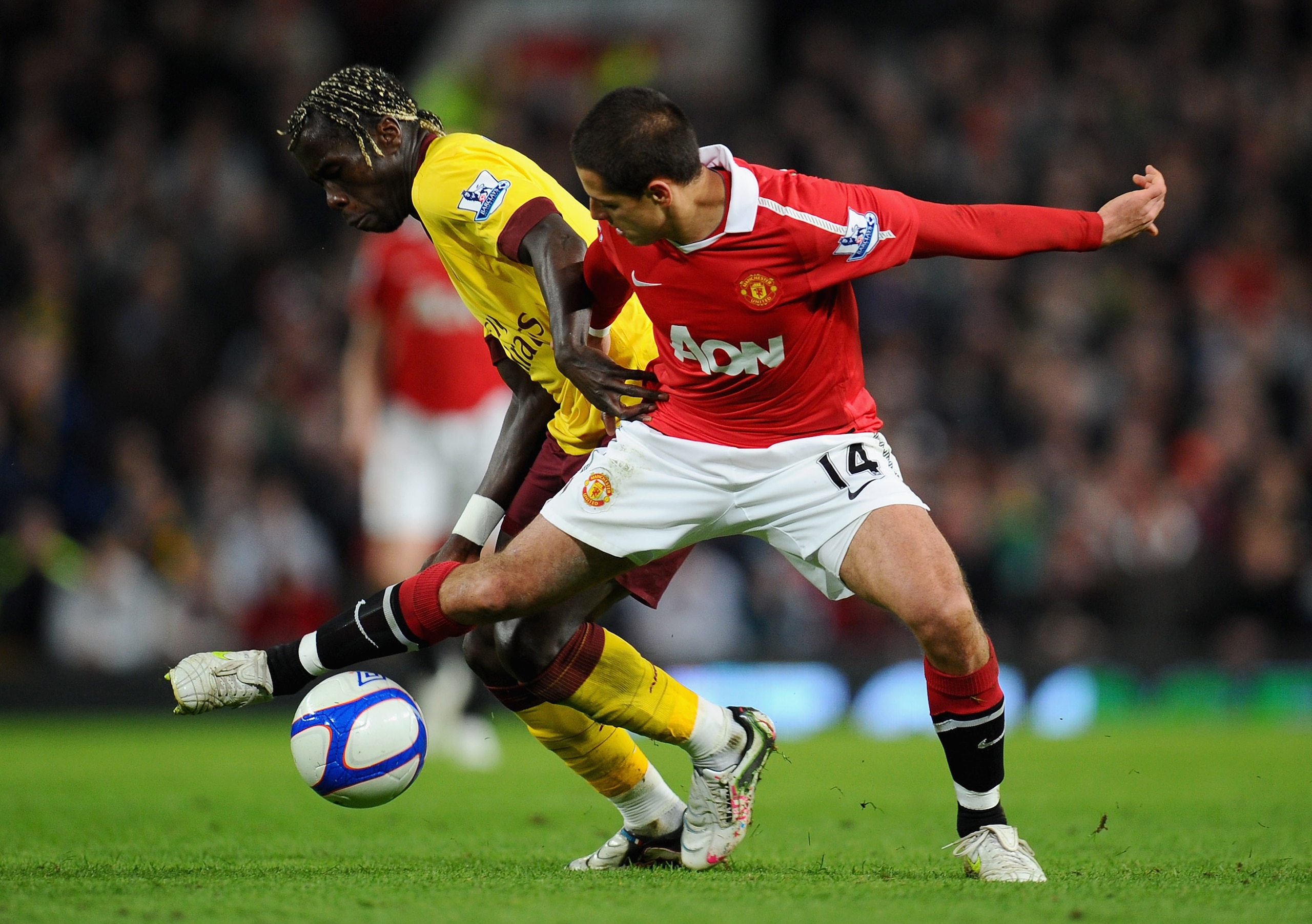 MANCHESTER, ENGLAND - MARCH 12:  Bacary Sagna of Arsenal and Javier Hernandez of Manchester United battle for the ball during the FA Cup sponsored by E.On Sixth Round match between Manchester United and Arsenal at Old Trafford on March 12, 2011 in Manches