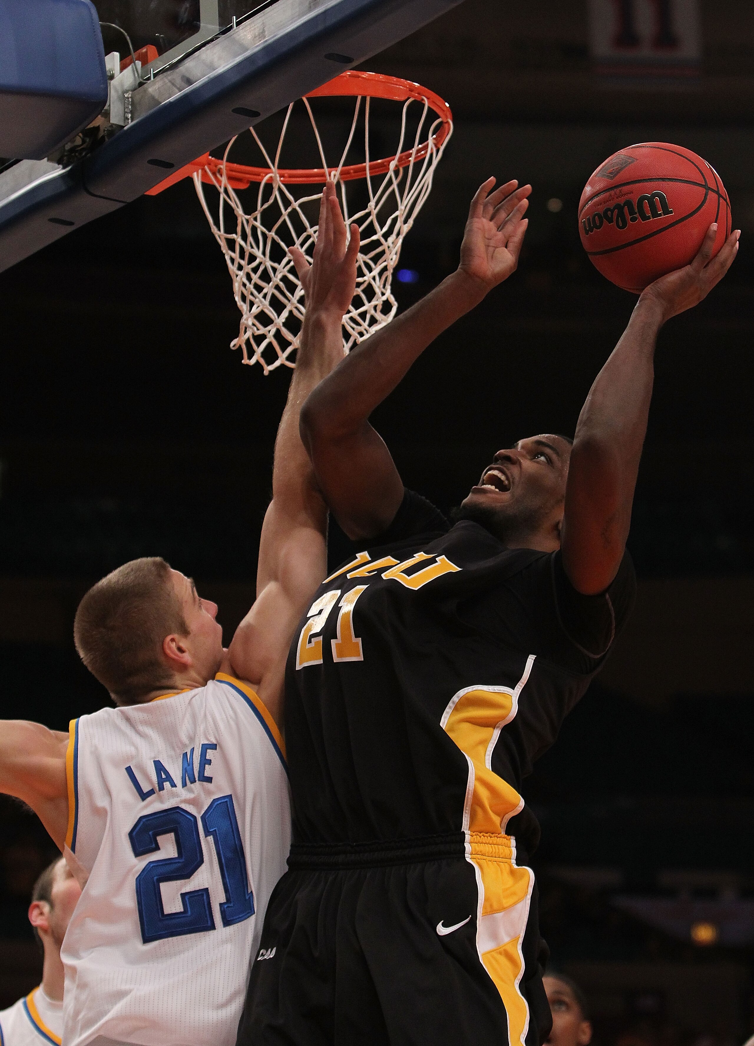 NEW YORK - NOVEMBER 26:  Jamie Skeen #21 of the Virginia Commonwealth Rams shoots over Brendan Lane #21 of the UCLA Bruins during their consolation game at Madison Square Garden on November 26, 2010 in New York City.  (Photo by Nick Laham/Getty Images)