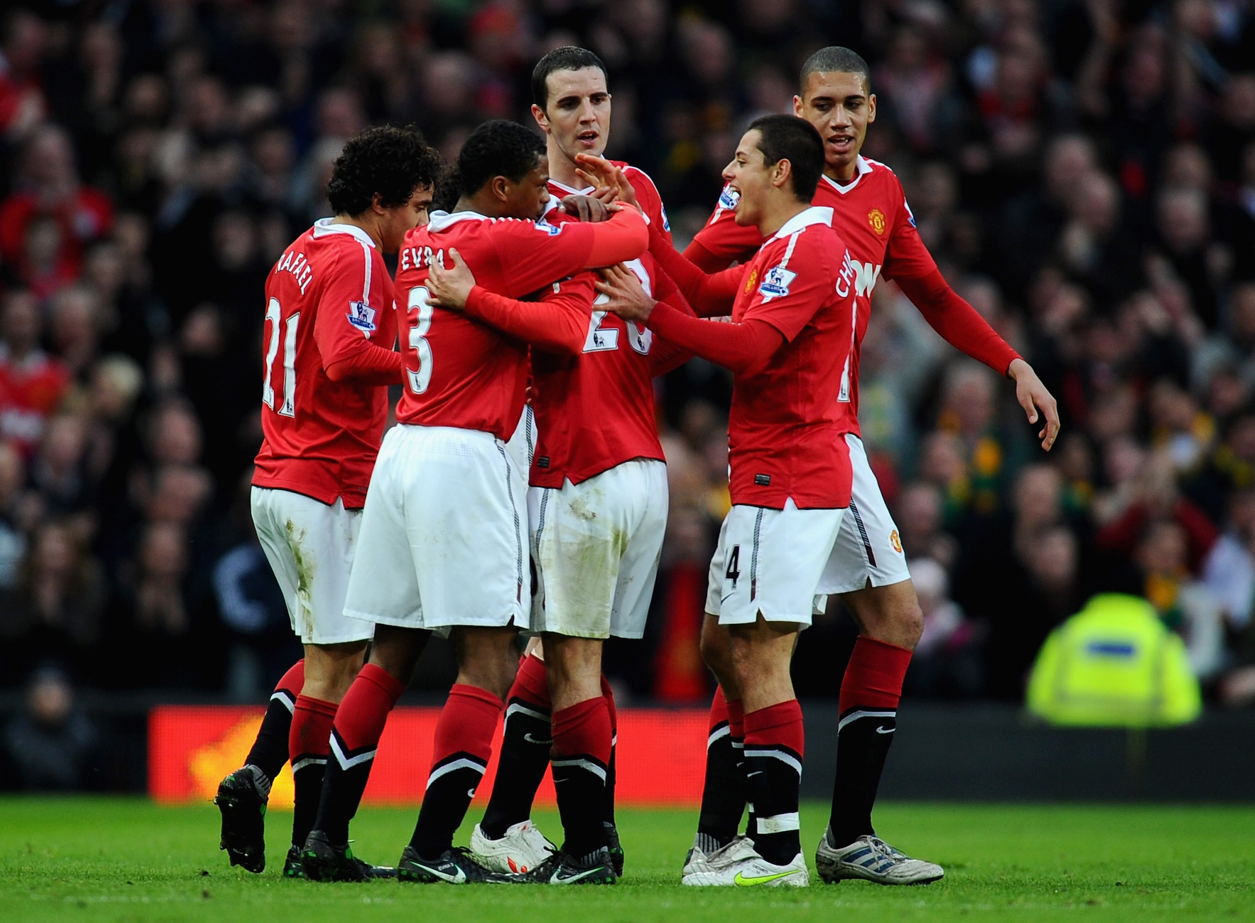 MANCHESTER, ENGLAND - MARCH 12:  Fabio Da Silva of Manchester United (C) celebrates scoring the opening goal with teammates (L-R) Rafael Da Silva, Patrice Evra, John O'Shea, Javier Hernandez and Chris Smalling during the FA Cup sponsored by E.On Sixth Rou