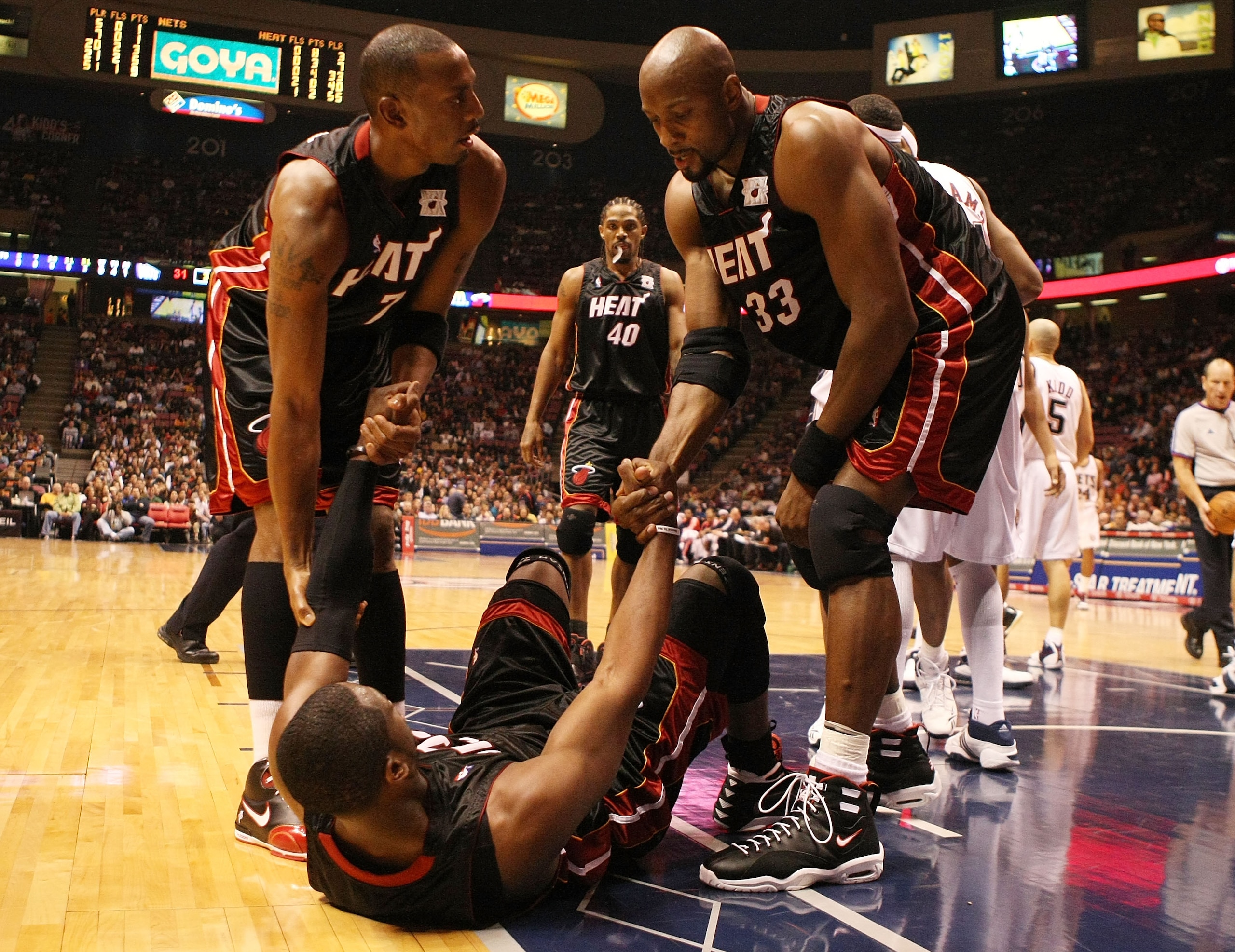 EAST RUTHERFORD, NJ - NOVEMBER 17: Dwyane Wade #3 of the Miami Heat is helped up by Anfernee Hardaway #7 and Alonzo Mourning #33 against the New Jersey Nets during their game on November 17, 2007 at the Izod Arena in East Rutherford, New Jersey. (Photo EAST RUTHERFORD, NJ - NOVEMBER 17: Dwyane Wade #3 of the Miami Heat is helped up by Anfernee Hardaway #7 and Alonzo Mourning #33 against the New Jersey Nets during their game on November 17, 2007 at the Izod Arena in East Rutherford, New Jersey. (Photo