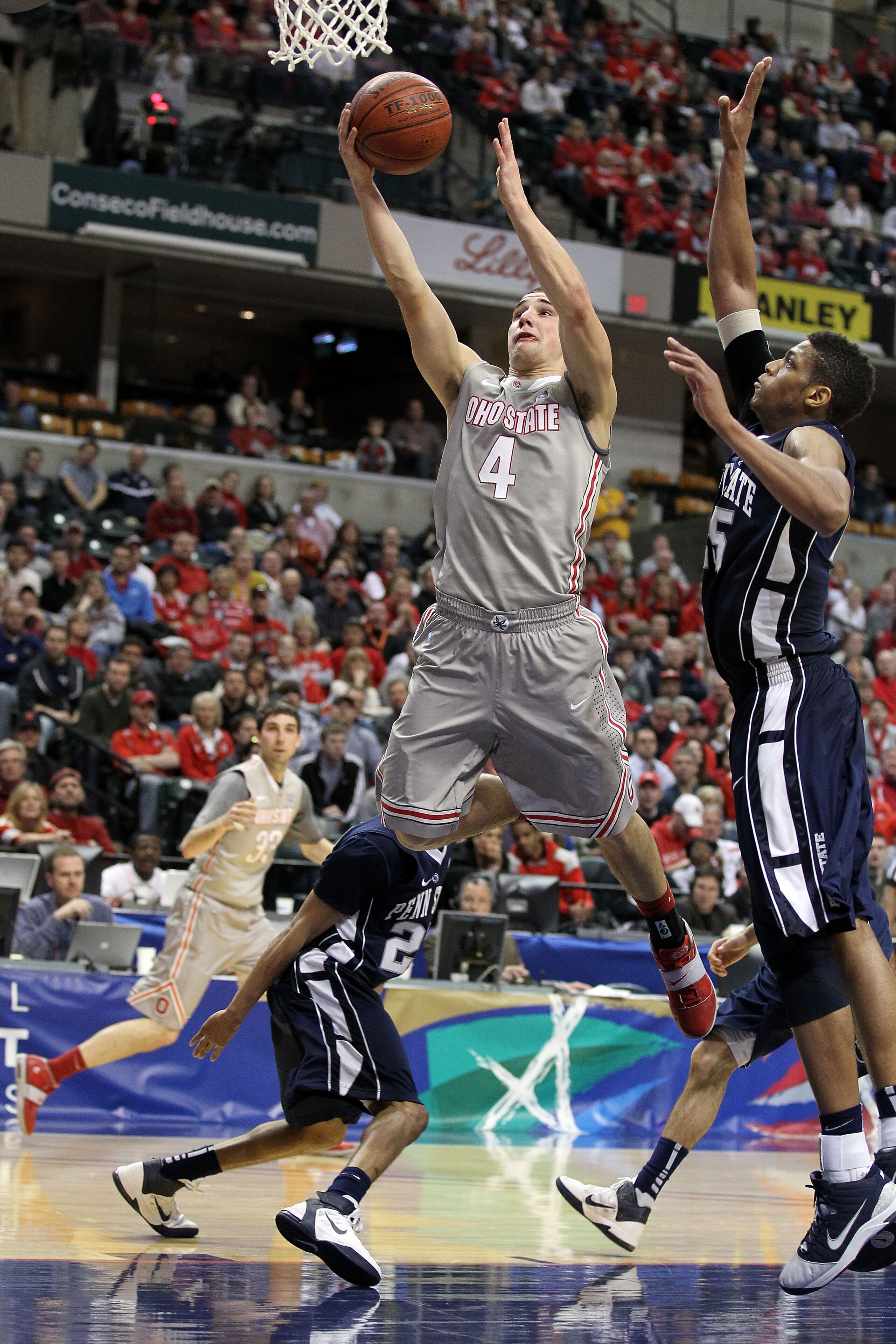 INDIANAPOLIS, IN - MARCH 13:  Aaron Craft #4 of the Ohio State Buckeyes drives for a shot attempt against the Penn State Nittany Lions during the championship game of the 2011 Big Ten Men's Basketball Tournament at Conseco Fieldhouse on March 13, 2011 in