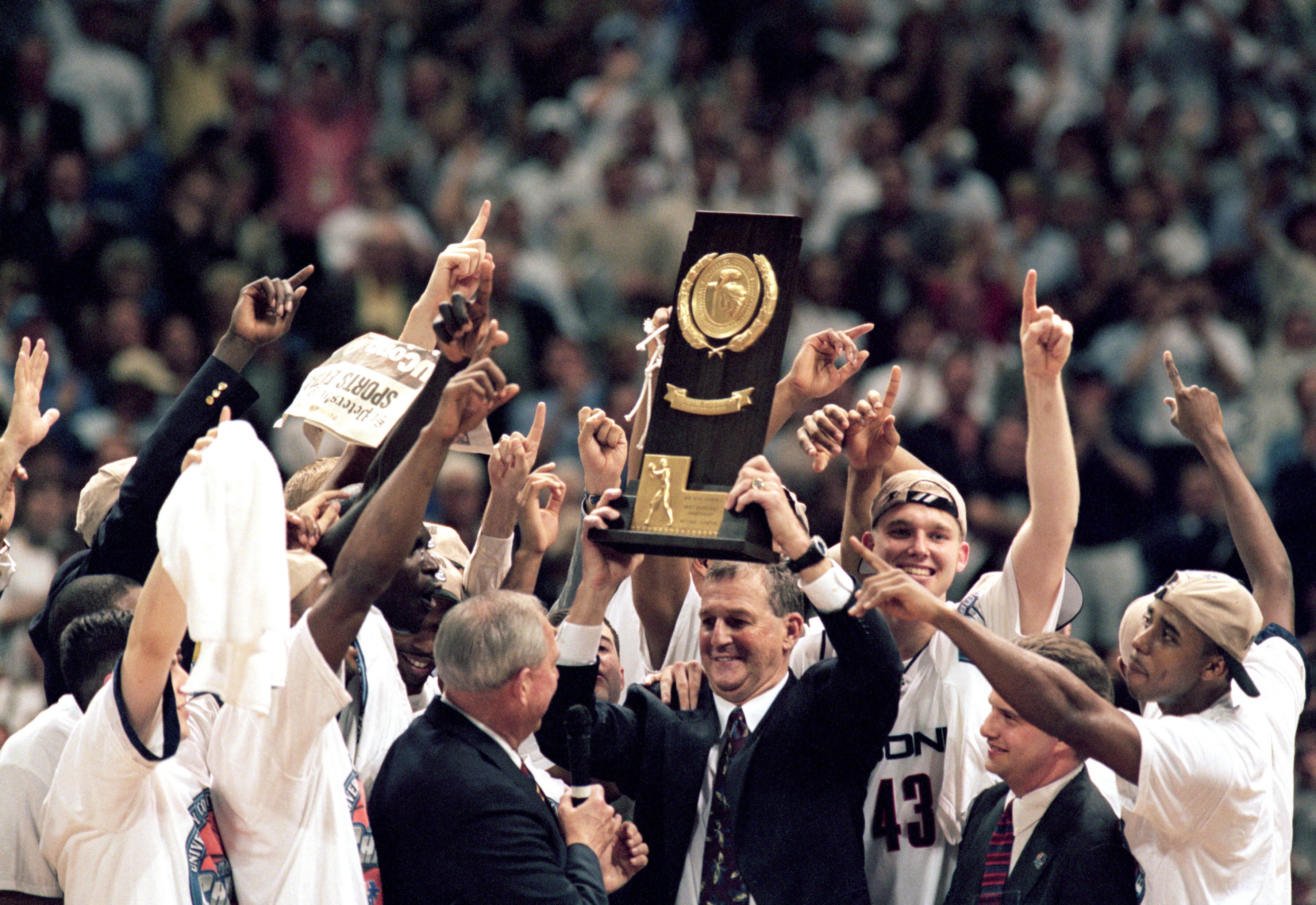 ST. PETERSBURG, FL - MARCH 23:  The UConn Huskies celebrates as head coach Jim Calhoun holds up the trophy after the NCAA Championship game against Duke University Blue Devils at the Tropicana Field on March 23, 1999 in St. Petersburg, Florida.  The Huski