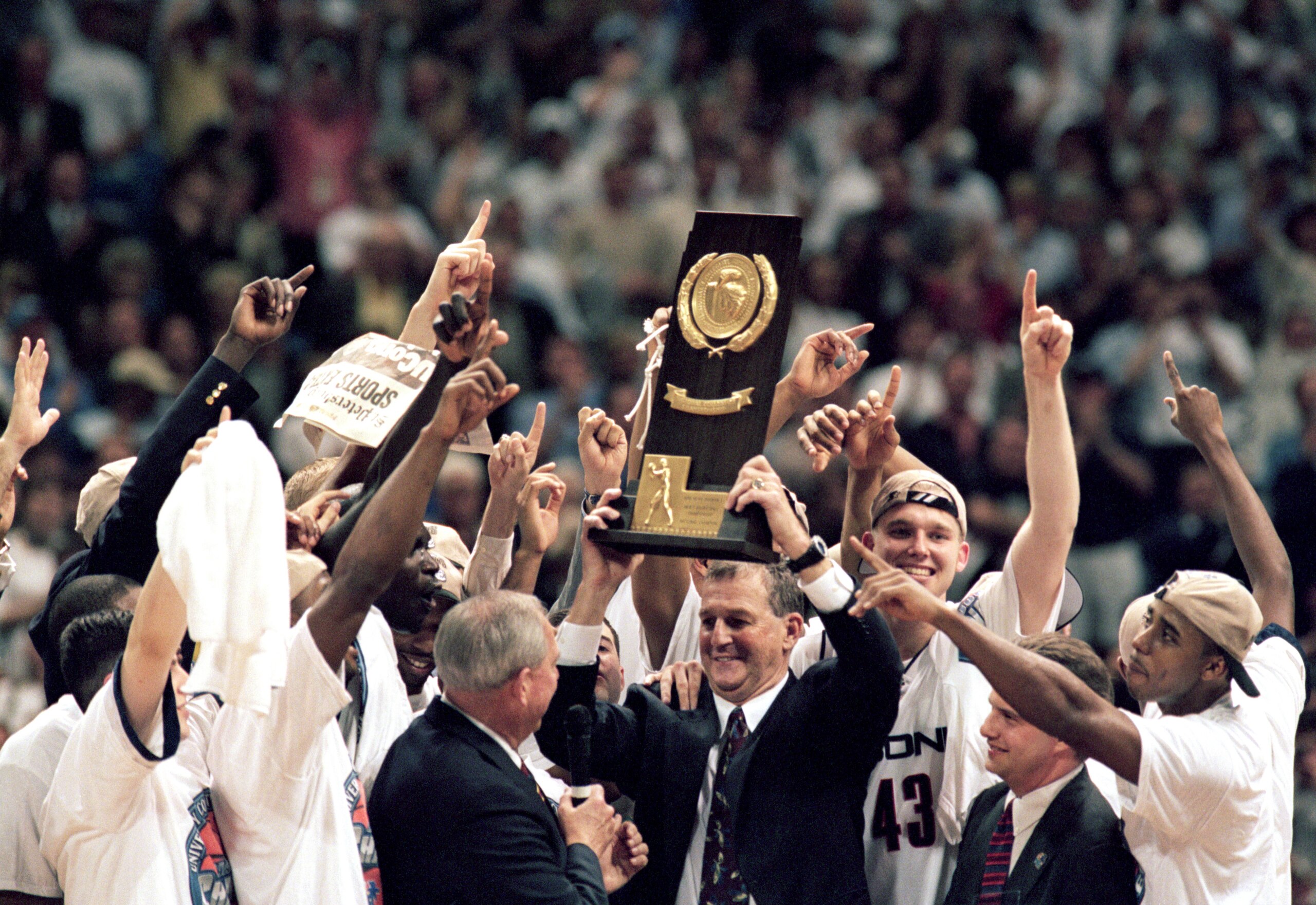 ST. PETERSBURG, FL - MARCH 23:  The UConn Huskies celebrates as head coach Jim Calhoun holds up the trophy after the NCAA Championship game against Duke University Blue Devils at the Tropicana Field on March 23, 1999 in St. Petersburg, Florida.  The Huski