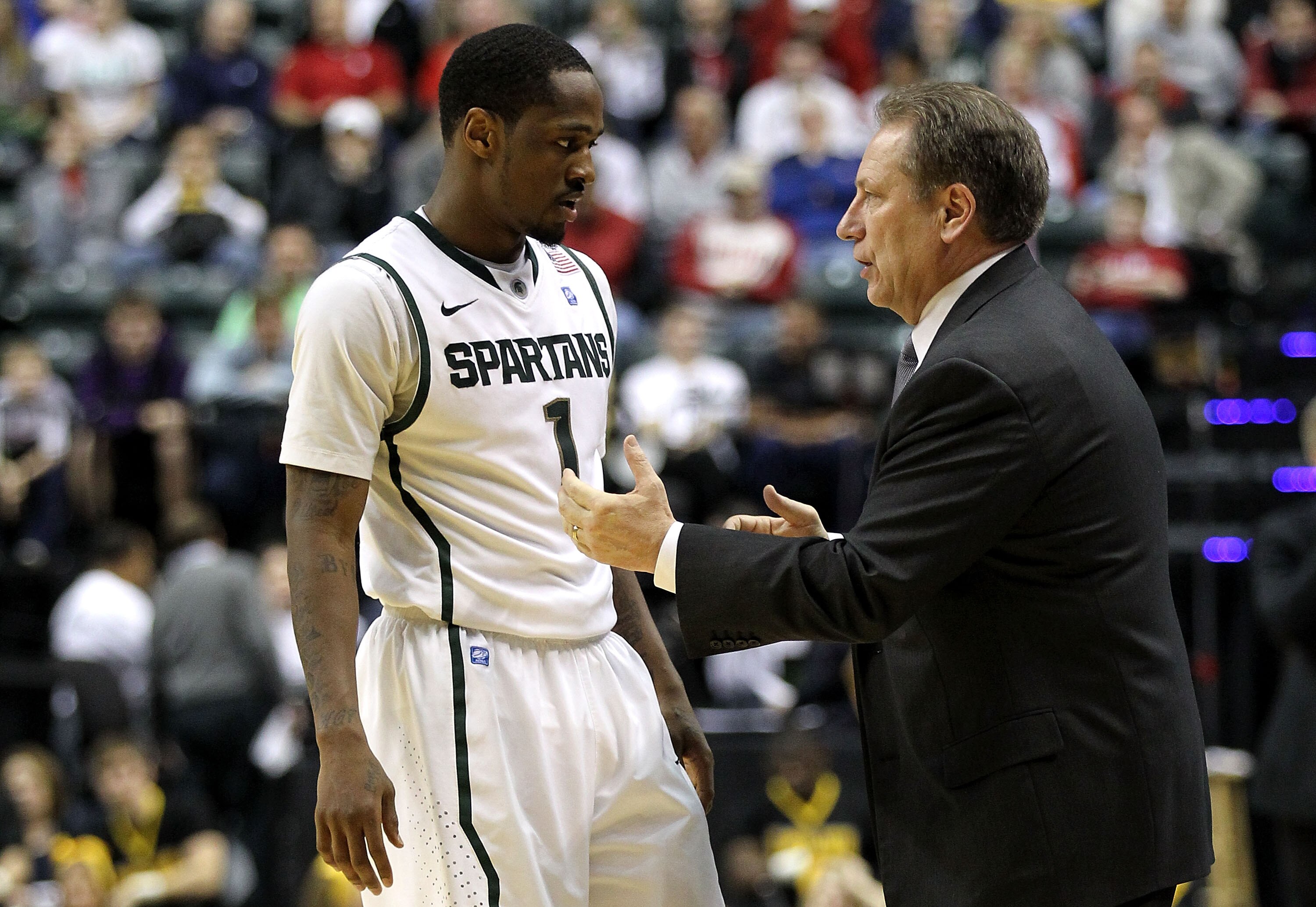 INDIANAPOLIS, IN - MARCH 10:  Head coach Tom Izzo and Kalin Lucas #1 of the Michigan State Spartans talk on the sideline against the Iowa Hawkeyes during the first round of the 2011 Big Ten Men's Basketball Tournament at Conseco Fieldhouse on March 10, 20