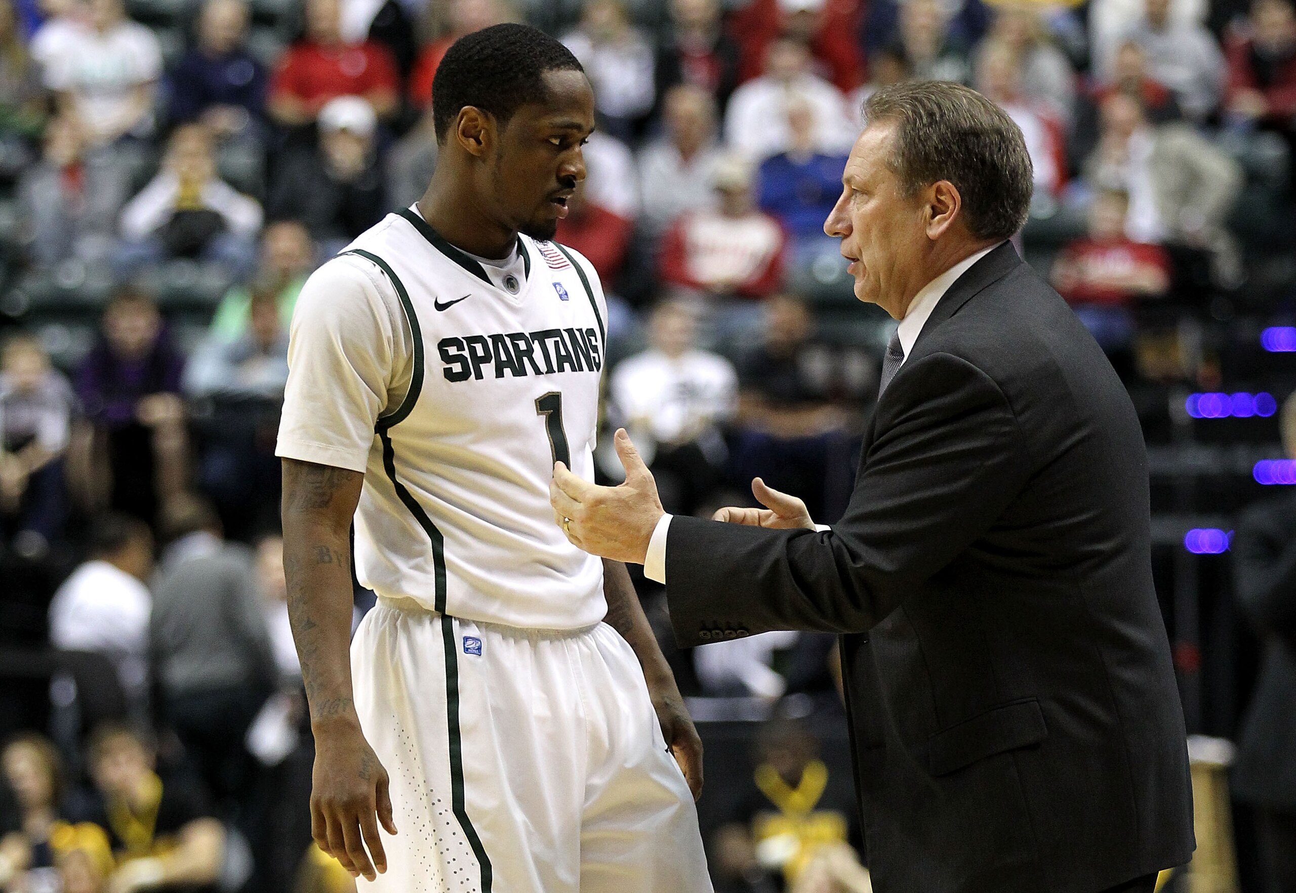 INDIANAPOLIS, IN - MARCH 10:  Head coach Tom Izzo and Kalin Lucas #1 of the Michigan State Spartans talk on the sideline against the Iowa Hawkeyes during the first round of the 2011 Big Ten Men's Basketball Tournament at Conseco Fieldhouse on March 10, 20