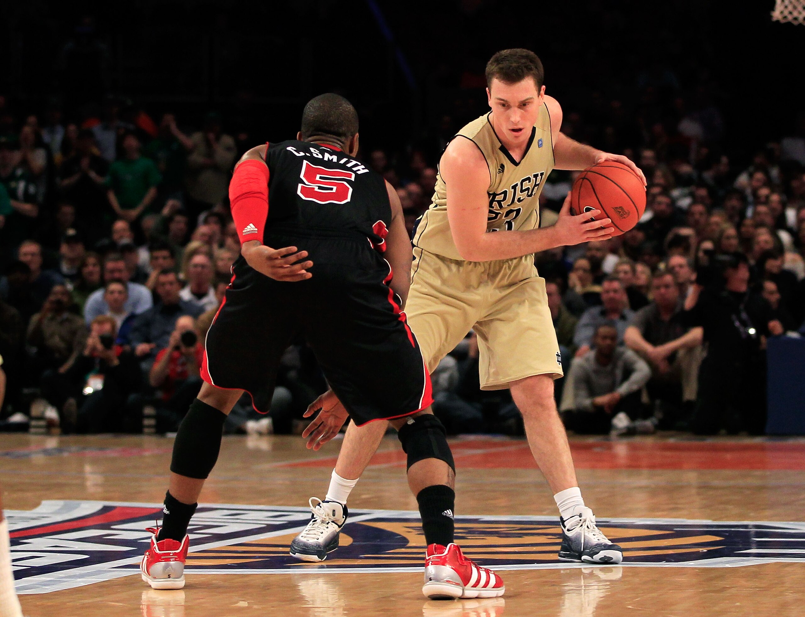 NEW YORK, NY - MARCH 11: Ben Hansbrough #23 of the Notre Dame Fighting Irish handles the ball against Chris Smith #5 of the Louisville Cardinals during the semifinals of the 2011 Big East Men's Basketball Tournament presented by American Eagle Outfitters