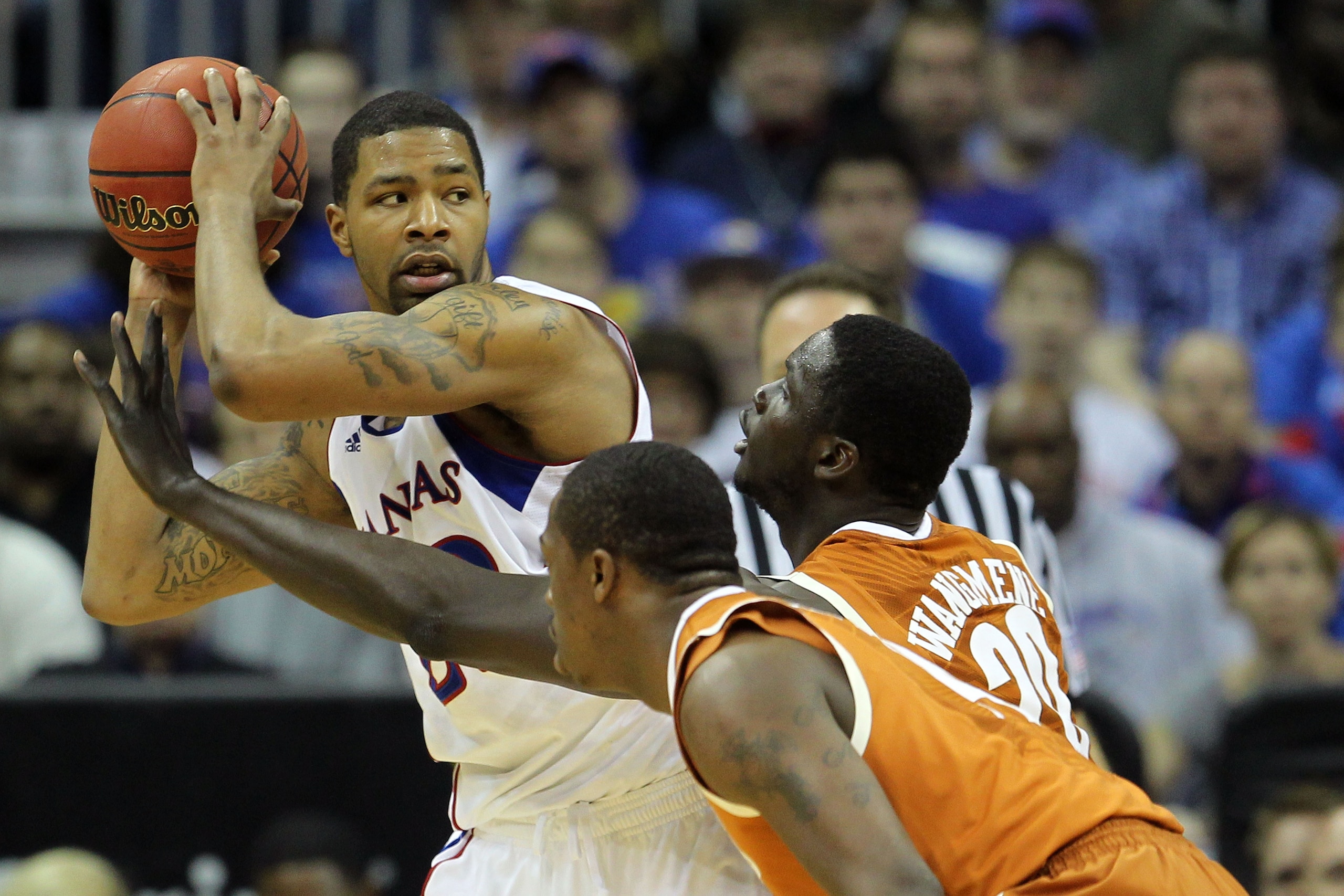 KANSAS CITY, MO - MARCH 12:  Marcus Morris #22 of the Kansas Jayhawks looks to move the ball against the Texas Longhorns in the first half of the 2011 Phillips 66 Big 12 Men's Basketball Tournament championship game at Sprint Center on March 12, 2011 in K