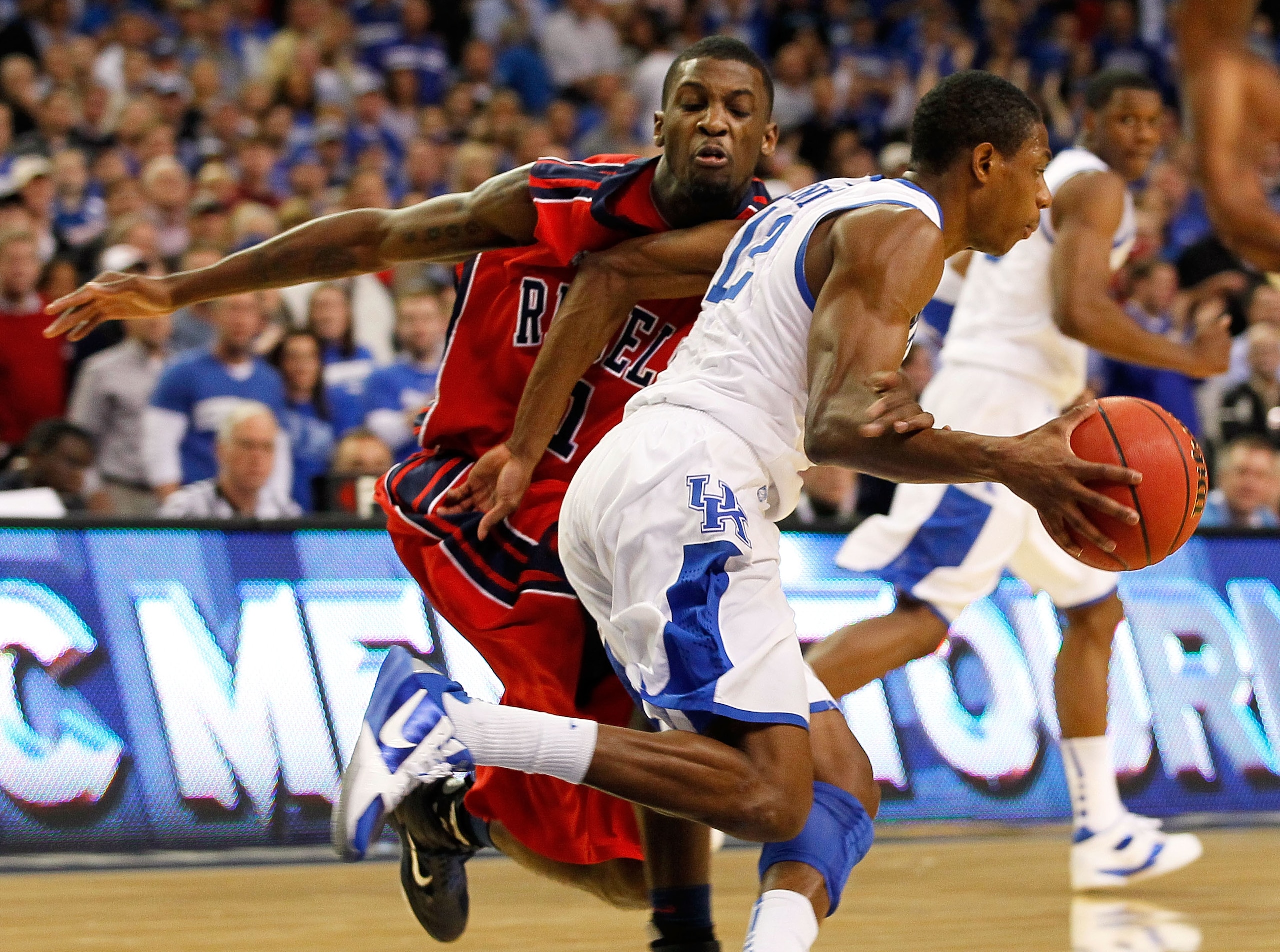 ATLANTA, GA - MARCH 11:  Brandon Knight #12 of the Kentucky Wildcats is fouled by Terrance Henry #1 of the Ole Miss Rebels in the second half during the quarterfinals of the SEC Men's Basketball Tournament at Georgia Dome on March 11, 2011 in Atlanta, Geo