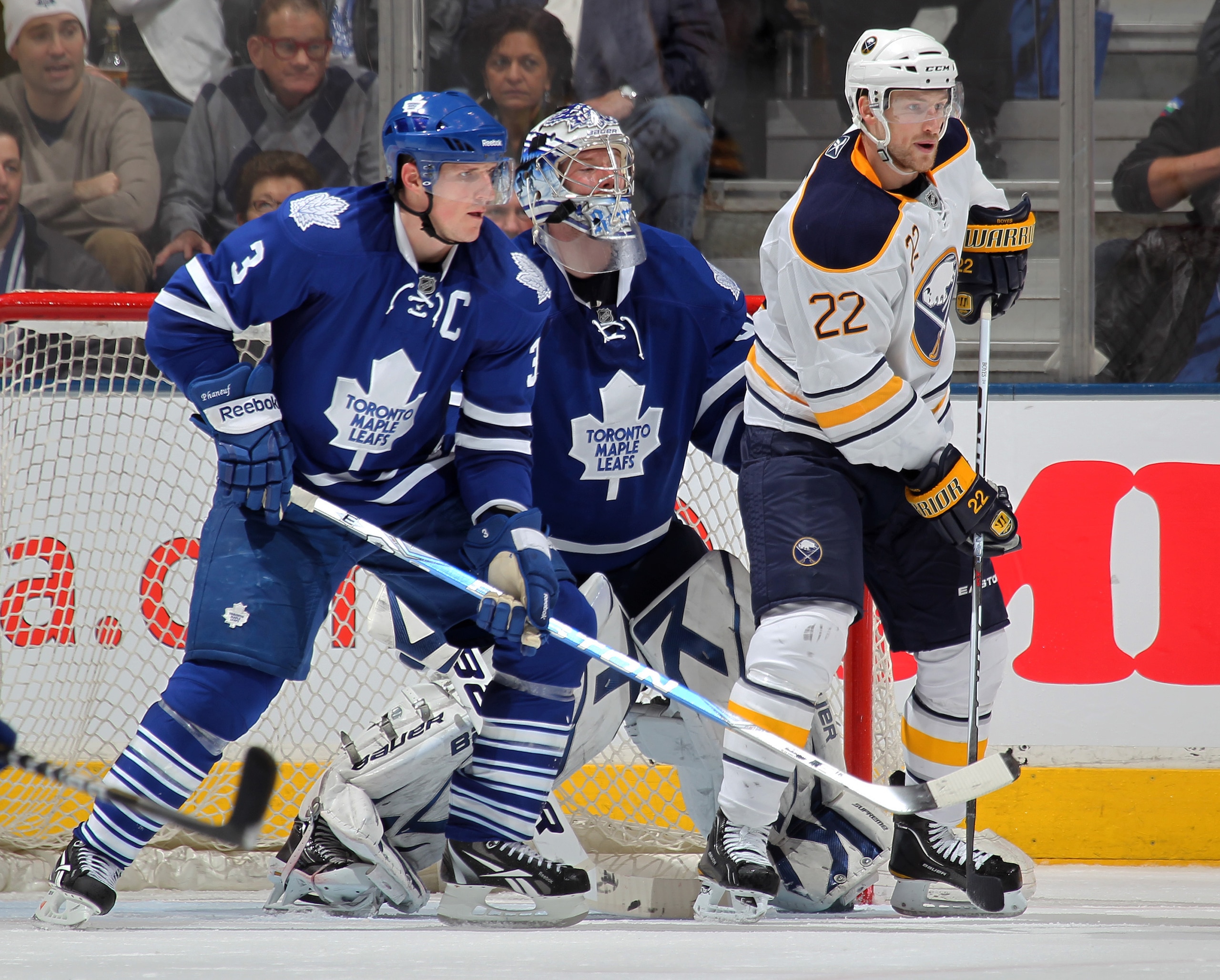 TORONTO, CANADA - MARCH 12:  Brad Boyes #22 of the Buffalo Sabres is held in check by Dion Phaneuf #3 of the Toronto Maple Leafs in a game on March 12, 2011 at the Air Canada Centre in Toronto, Canada. The Leafs defeated the Sabres 4-3. (Photo by Claus An
