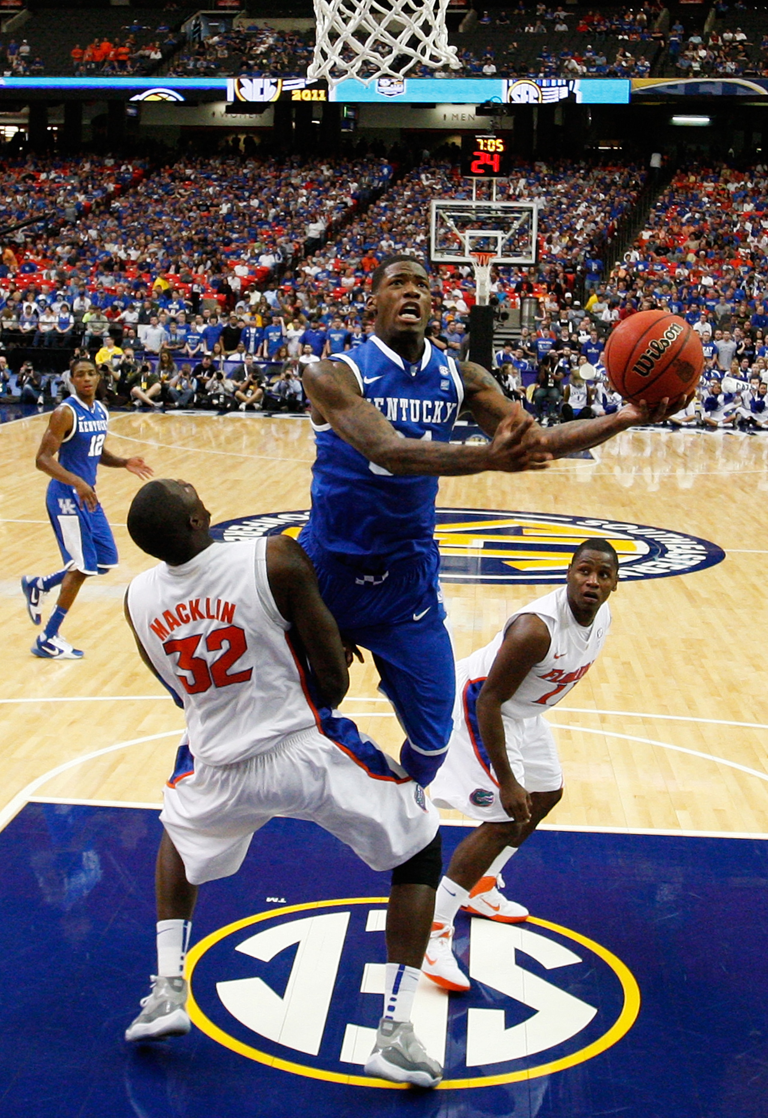 ATLANTA, GA - MARCH 13:  Deandre Liggins #34 of the Kentucky Wildcats shoots against Vernon Macklin #32 of the Florida Gators during the championship game of the SEC Men's Basketball Tournament at Georgia Dome on March 13, 2011 in Atlanta, Georgia. The Wi