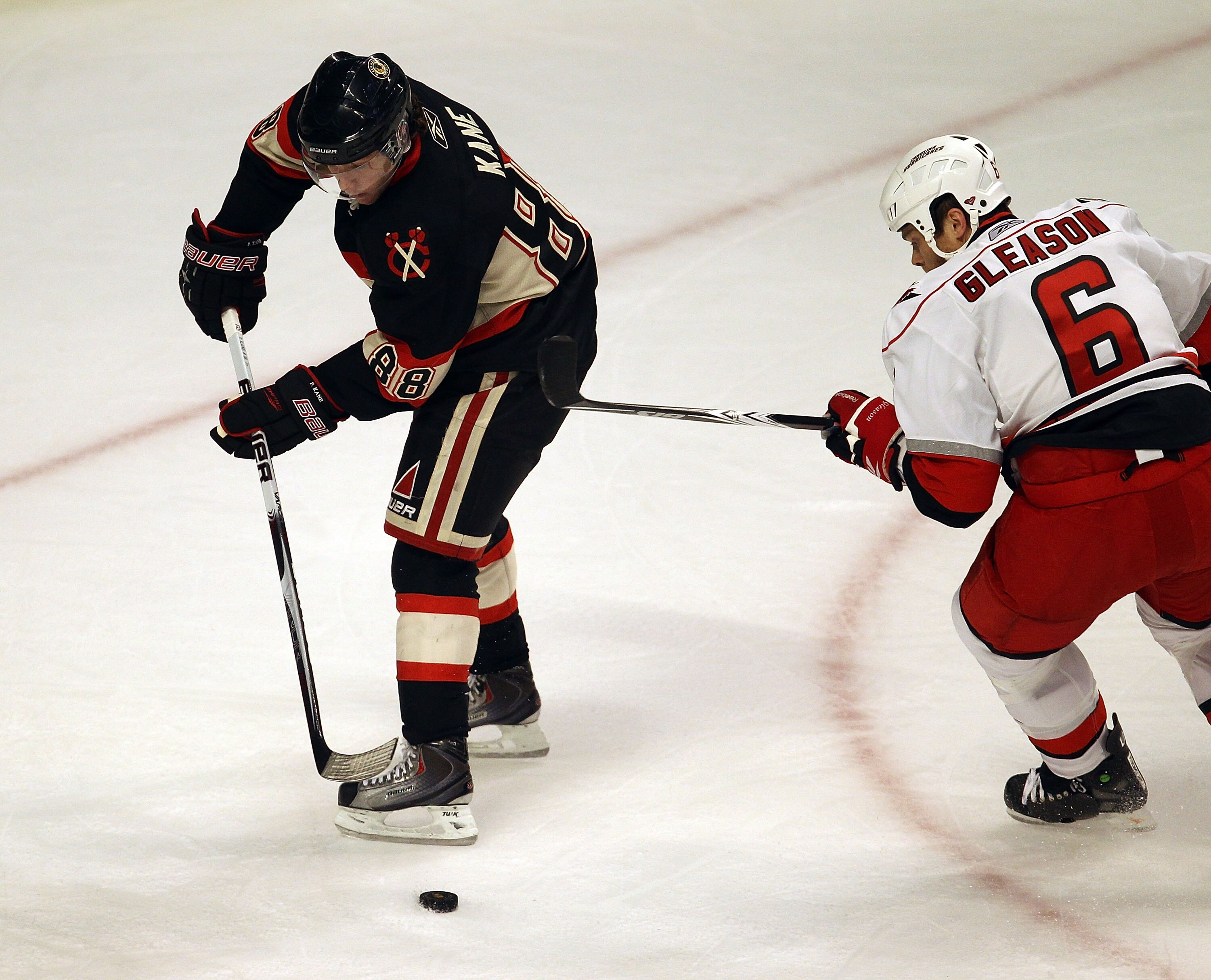 CHICAGO, IL - MARCH 04: Patrick Kane #88 of the Chicago Blackhawks controls the puck under pressure from Tim Gleason #6 of the Carolina Hurricanes at the United Center on March 4, 2011 in Chicago, Illinois. The Blackhawks defeated the Hurricanes 5-2.  (Ph
