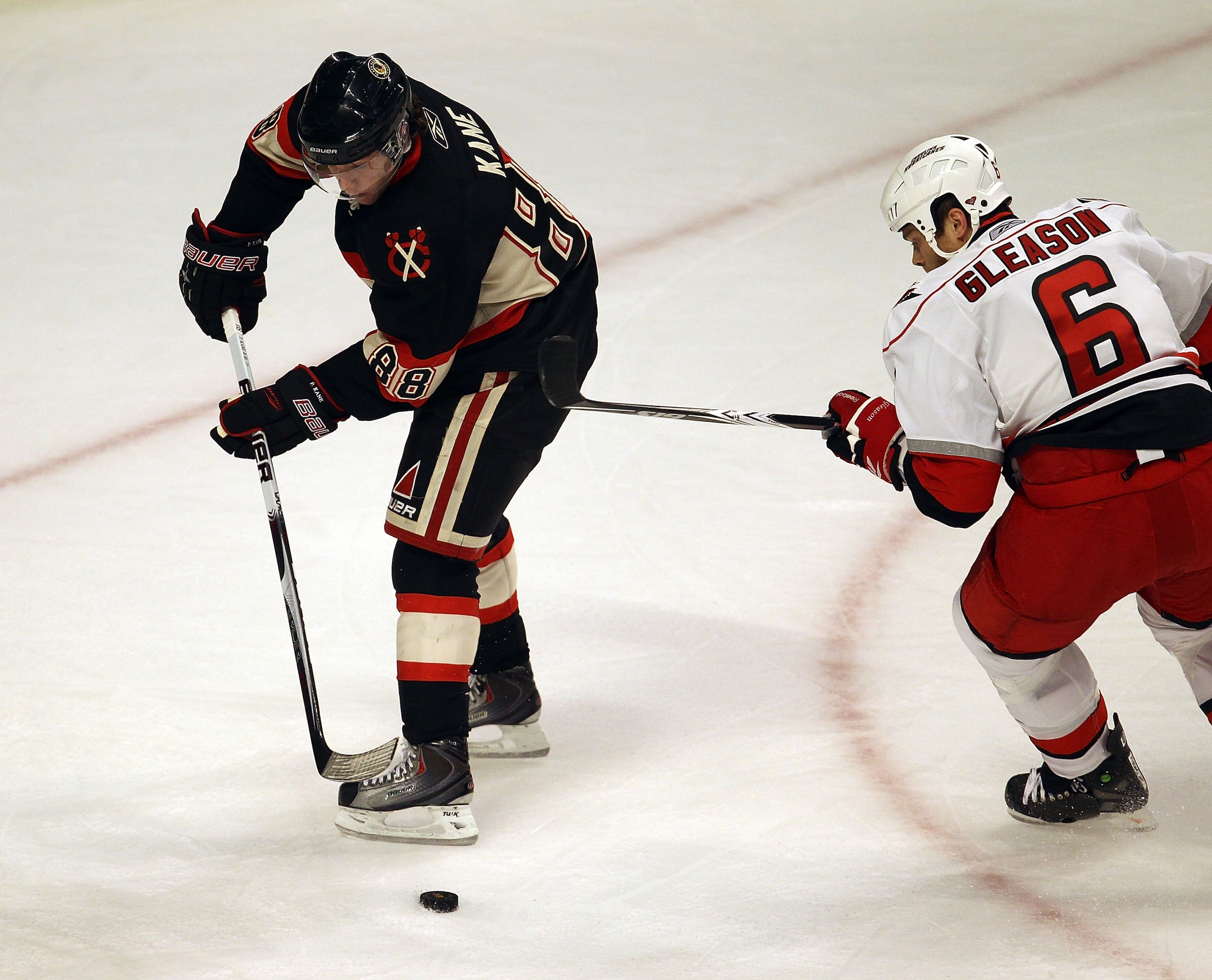 CHICAGO, IL - MARCH 04: Patrick Kane #88 of the Chicago Blackhawks controls the puck under pressure from Tim Gleason #6 of the Carolina Hurricanes at the United Center on March 4, 2011 in Chicago, Illinois. The Blackhawks defeated the Hurricanes 5-2.  (Ph