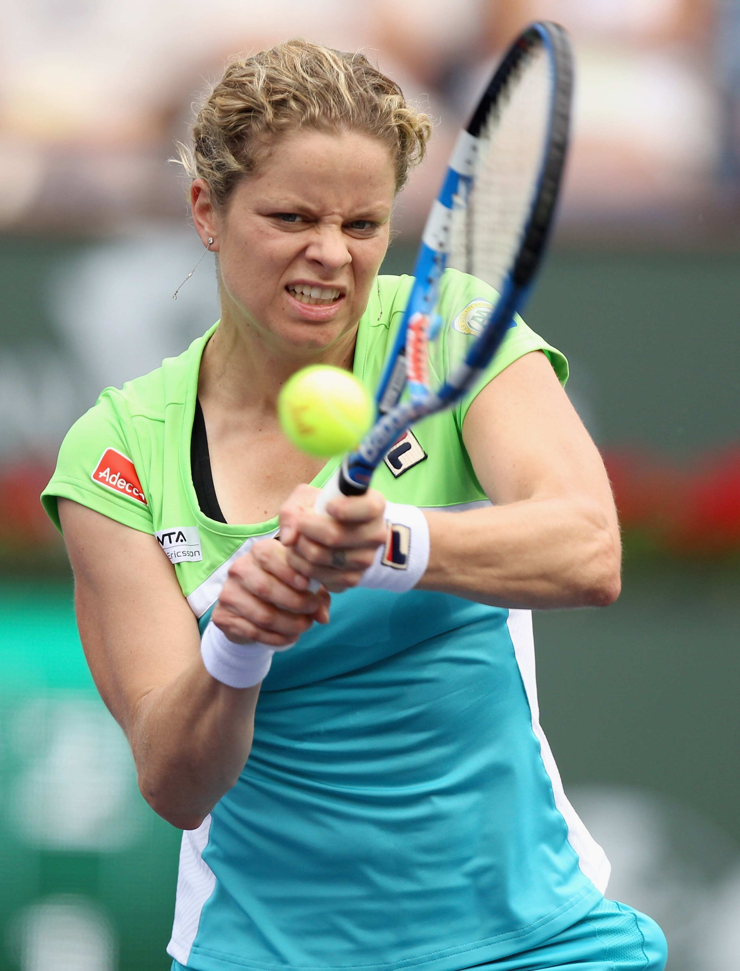 INDIAN WELLS, CA - MARCH 13:  Kim Clijsters of Belgium returns a shot to Sara Errani of Italy during the BNP Paribas Open at the Indian Wells Tennis Garden on March 13, 2011 in Indian Wells, California.  (Photo by Ezra Shaw/Getty Images)
