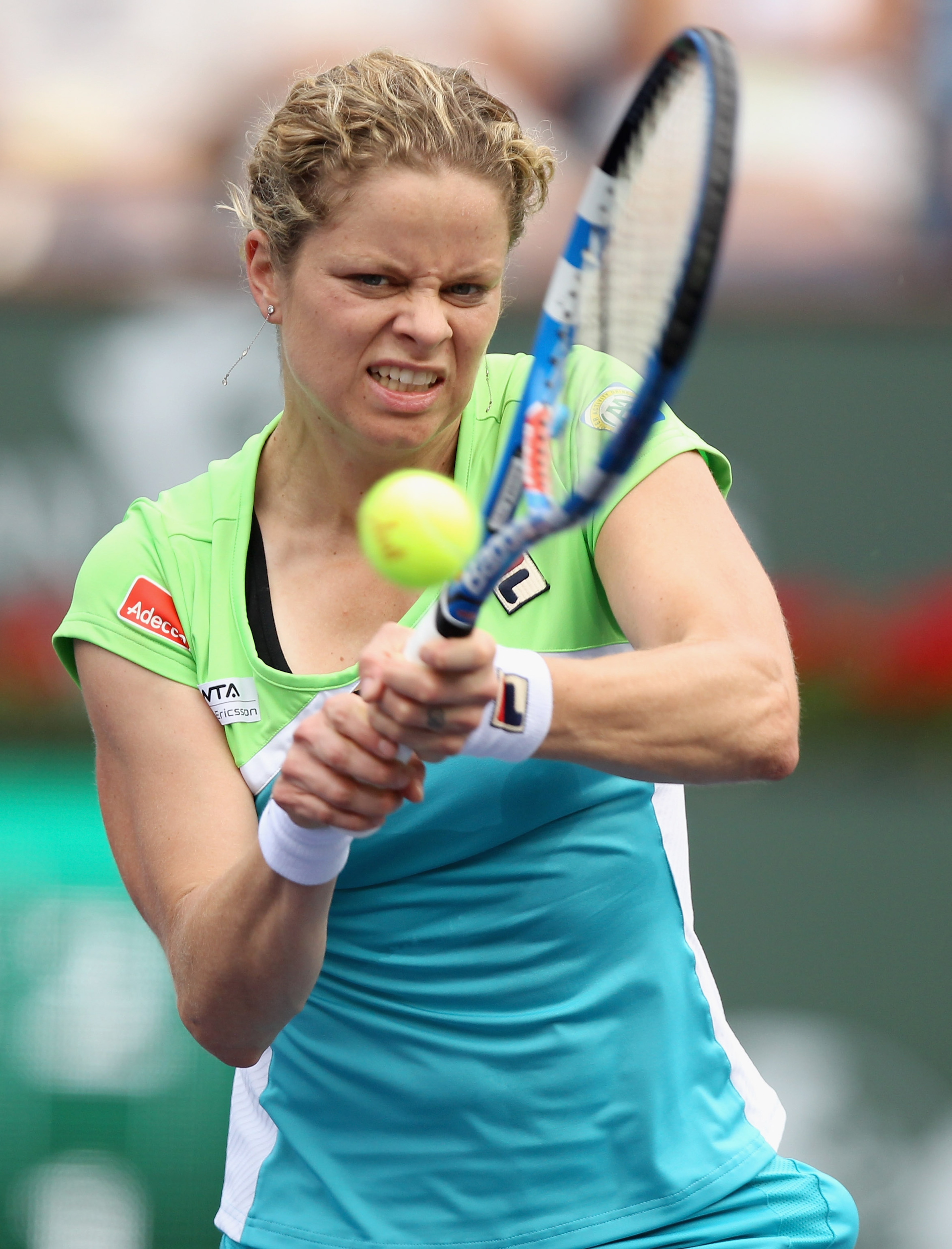 INDIAN WELLS, CA - MARCH 13:  Kim Clijsters of Belgium returns a shot to Sara Errani of Italy during the BNP Paribas Open at the Indian Wells Tennis Garden on March 13, 2011 in Indian Wells, California.  (Photo by Ezra Shaw/Getty Images)