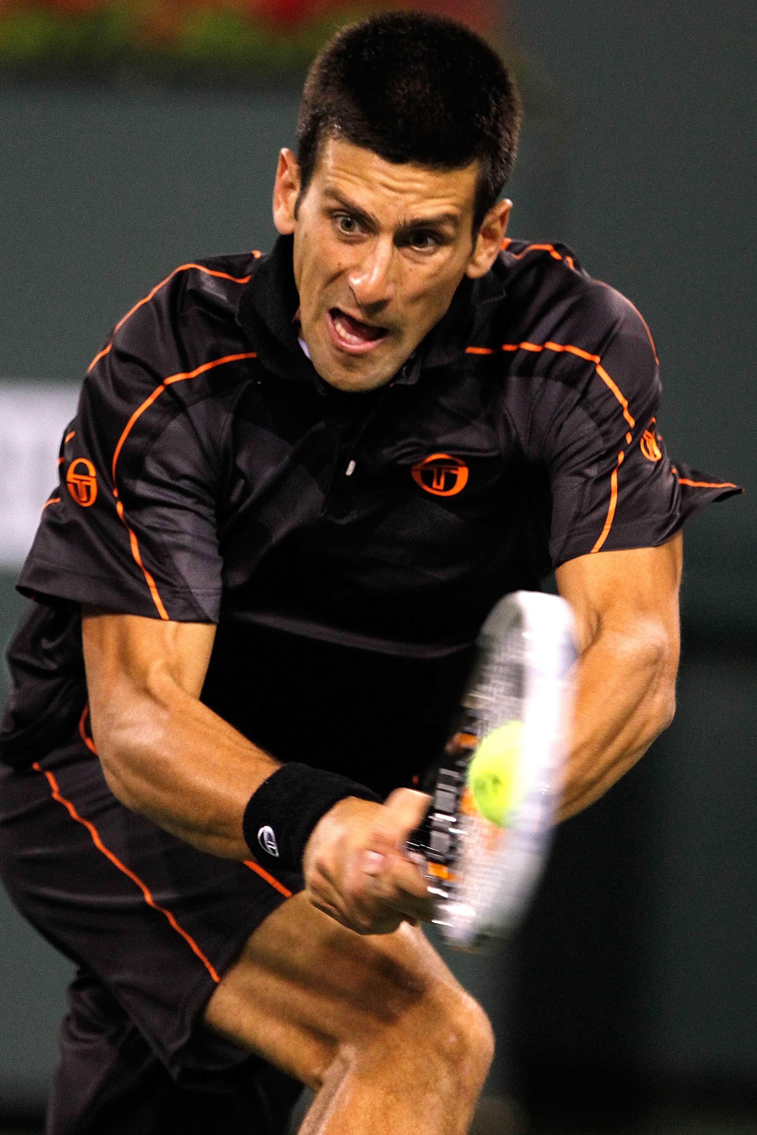INDIAN WELLS, CA - MARCH 13:  Novak Djokovic of Serbia returns a shot to Andrey Golubev of Kazicstan during the BNP Paribas Open at the Indian Wells Tennis Garden on March 13, 2011 in Indian Wells, California.  (Photo by Matthew Stockman/Getty Images)