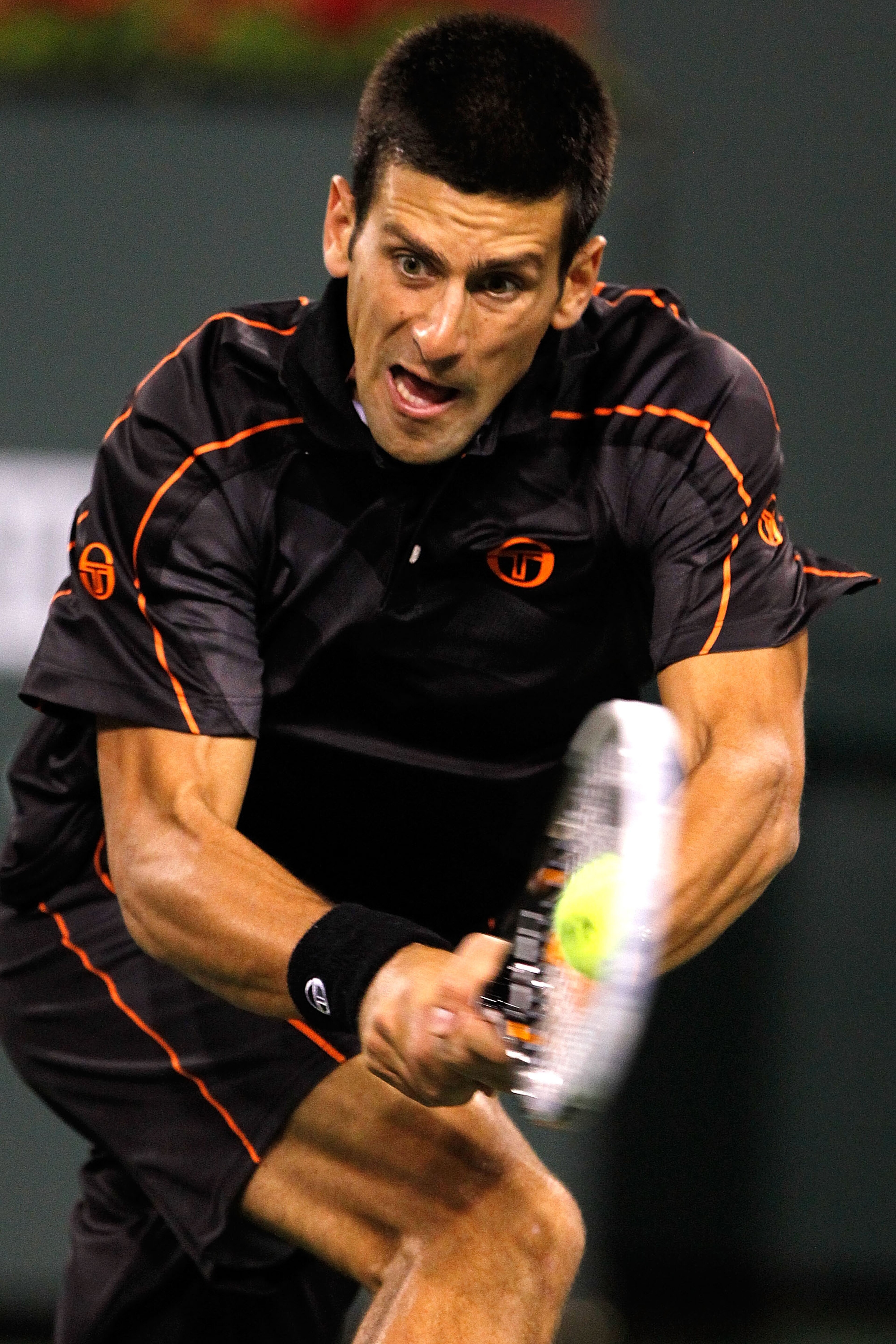 INDIAN WELLS, CA - MARCH 13:  Novak Djokovic of Serbia returns a shot to Andrey Golubev of Kazicstan during the BNP Paribas Open at the Indian Wells Tennis Garden on March 13, 2011 in Indian Wells, California.  (Photo by Matthew Stockman/Getty Images)