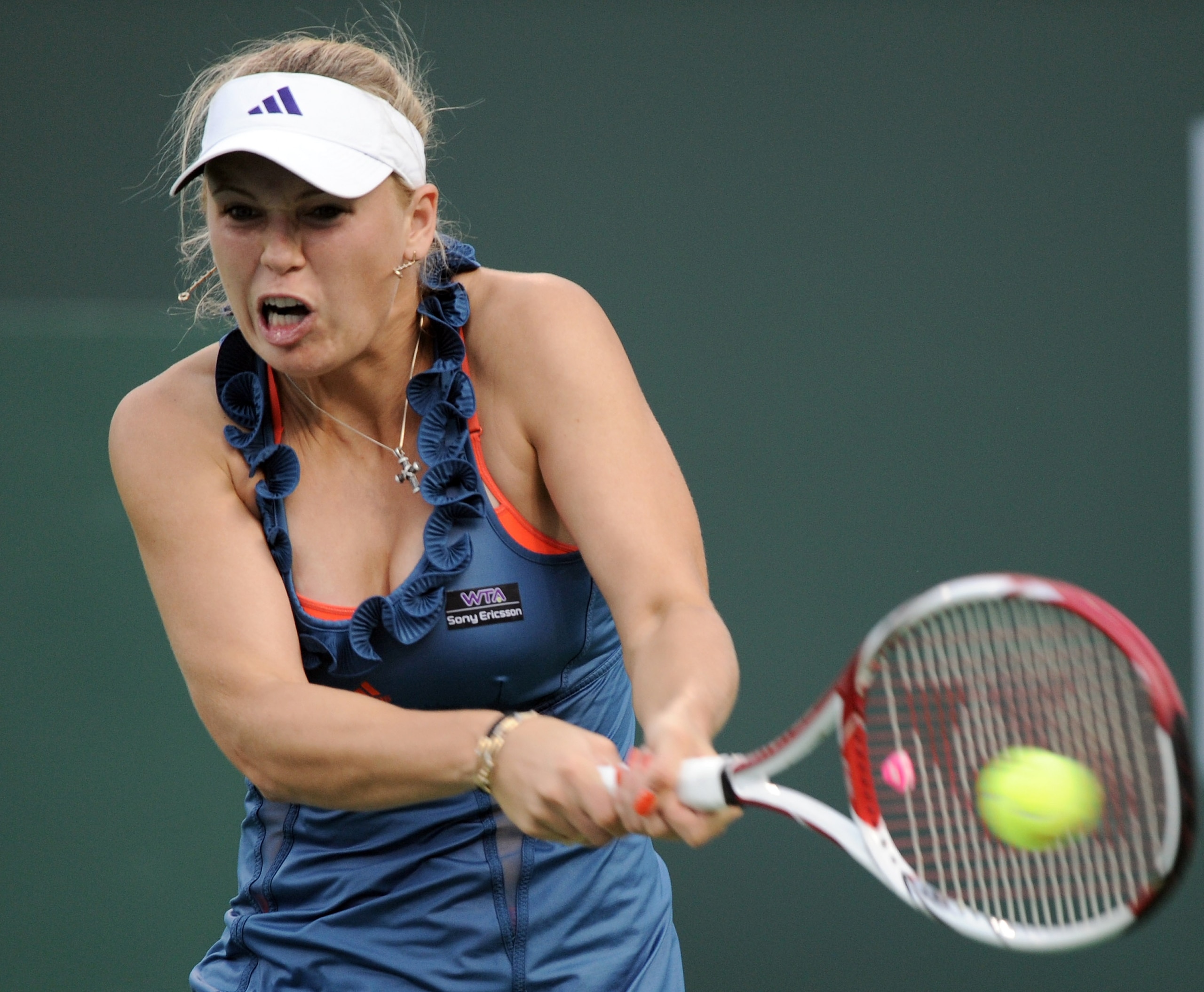 INDIAN WELLS, CA - MARCH 12:  Caroline Wozniacki of Denmark hits a backhand in her match against Sloane Stephens during the BNP Paribas Open at the Indian Wells Tennis Garden on March 12, 2011 in Indian Wells, California.  (Photo by Harry How/Getty Images