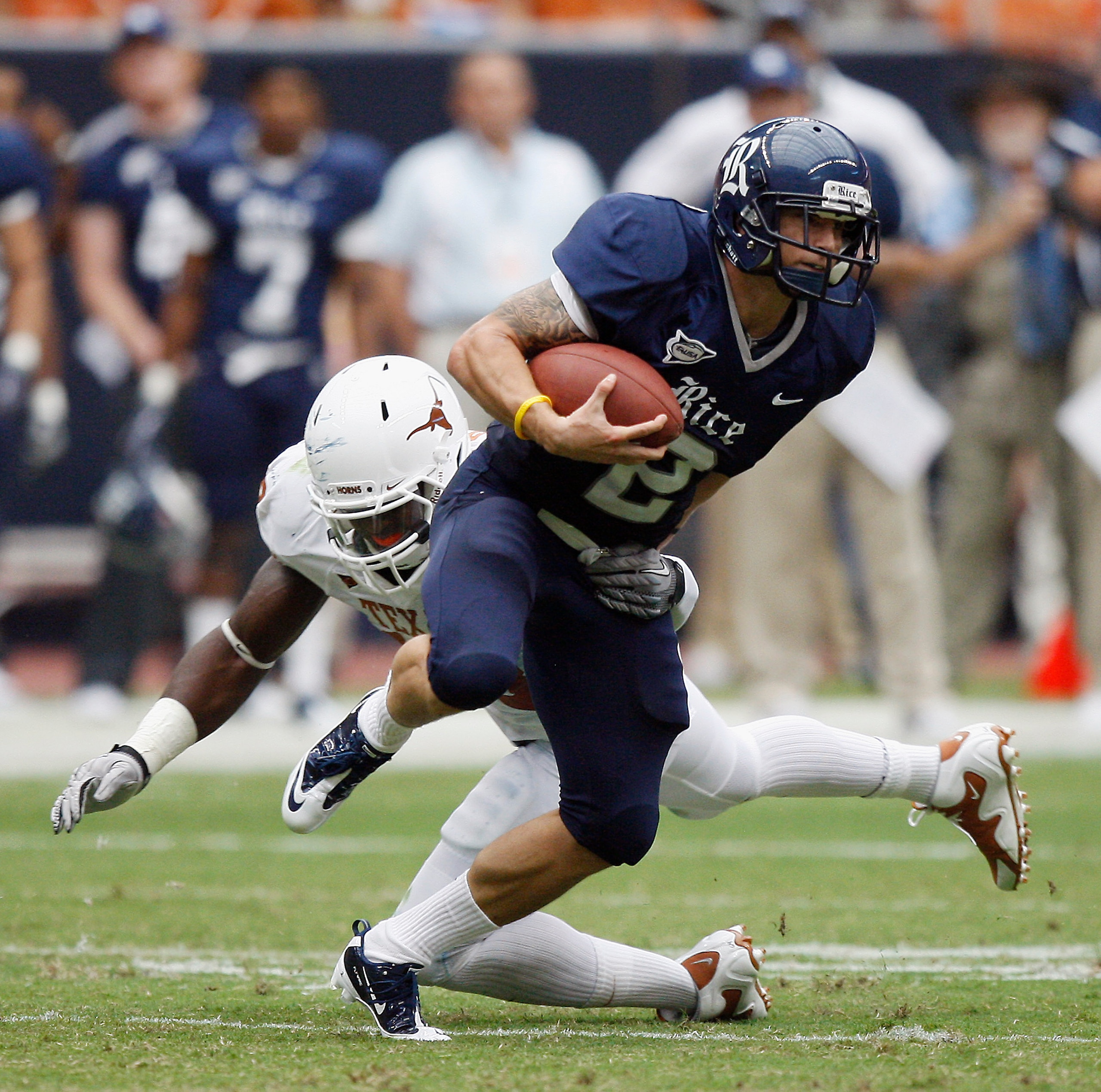 HOUSTON - SEPTEMBER 04:  Running back Sam McGuffie #2 of the Rice Owls rushes past safety Kenny Vaccaro #16 of the Texas Longhorns at Reliant Stadium on September 4, 2010 in Houston, Texas.  (Photo by Bob Levey/Getty Images)