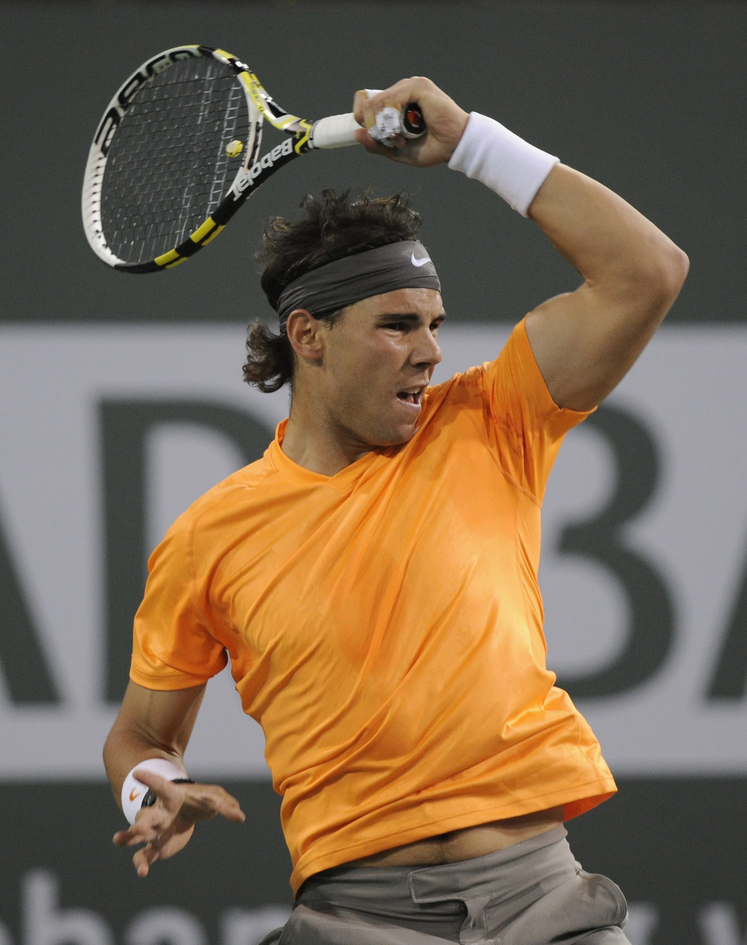 INDIAN WELLS, CA - MARCH 12:  Rafael Nadal of Spain hits a forehand in his match against Rik De Voest of South Africa during the BNP Paribas Open at the Indian Wells Tennis Garden on March 12, 2011 in Indian Wells, California.  (Photo by Harry How/Getty I