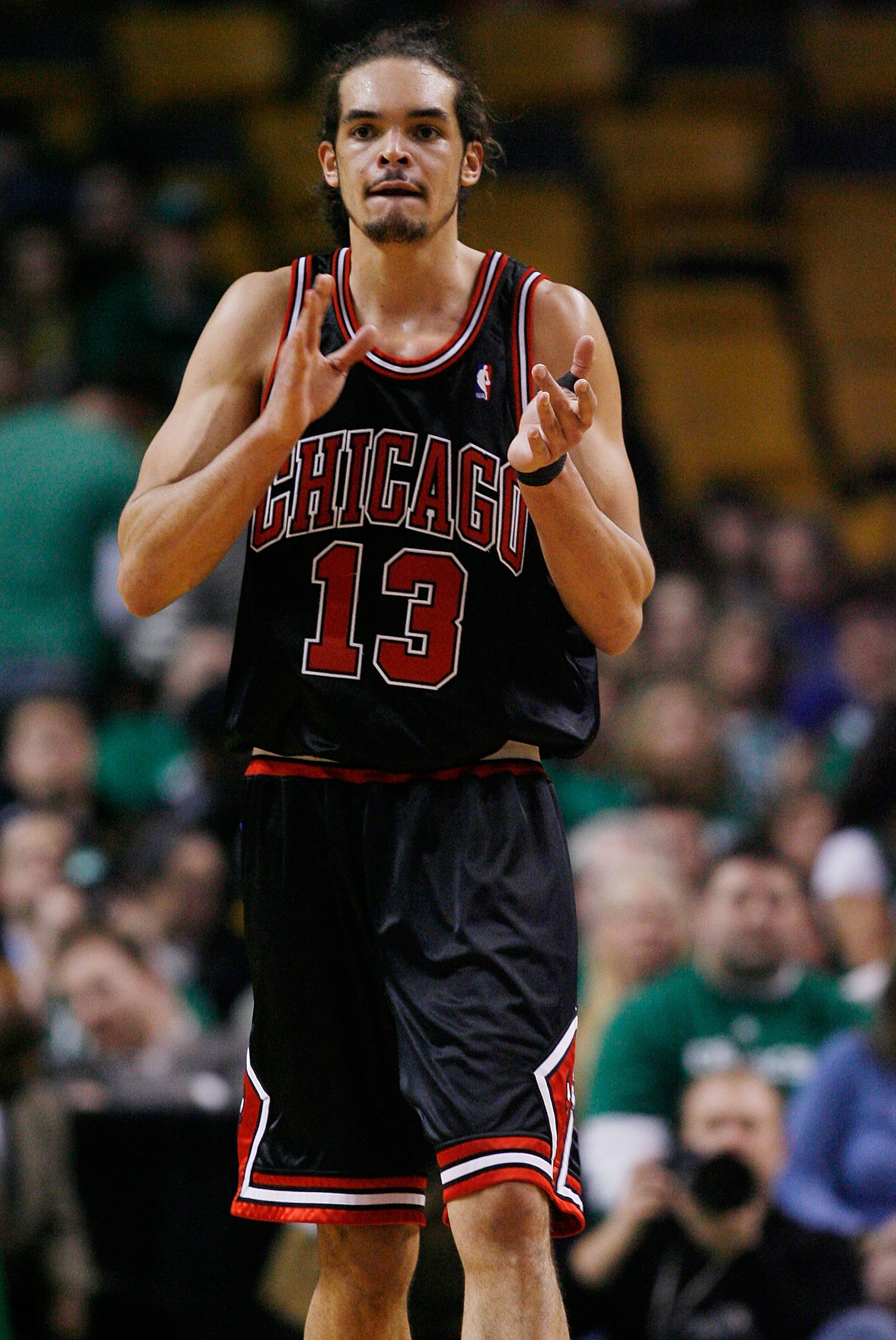 BOSTON - JANUARY 14:  Joakim Noah #13 of the Chicago Bulls celebrates in the fourth quarter against the Boston Celtics at the TD Garden on January 14, 2010 in Boston, Massachusetts. The Bulls defeated the Celtics 96-83. NOTE TO USER: User expressly acknow