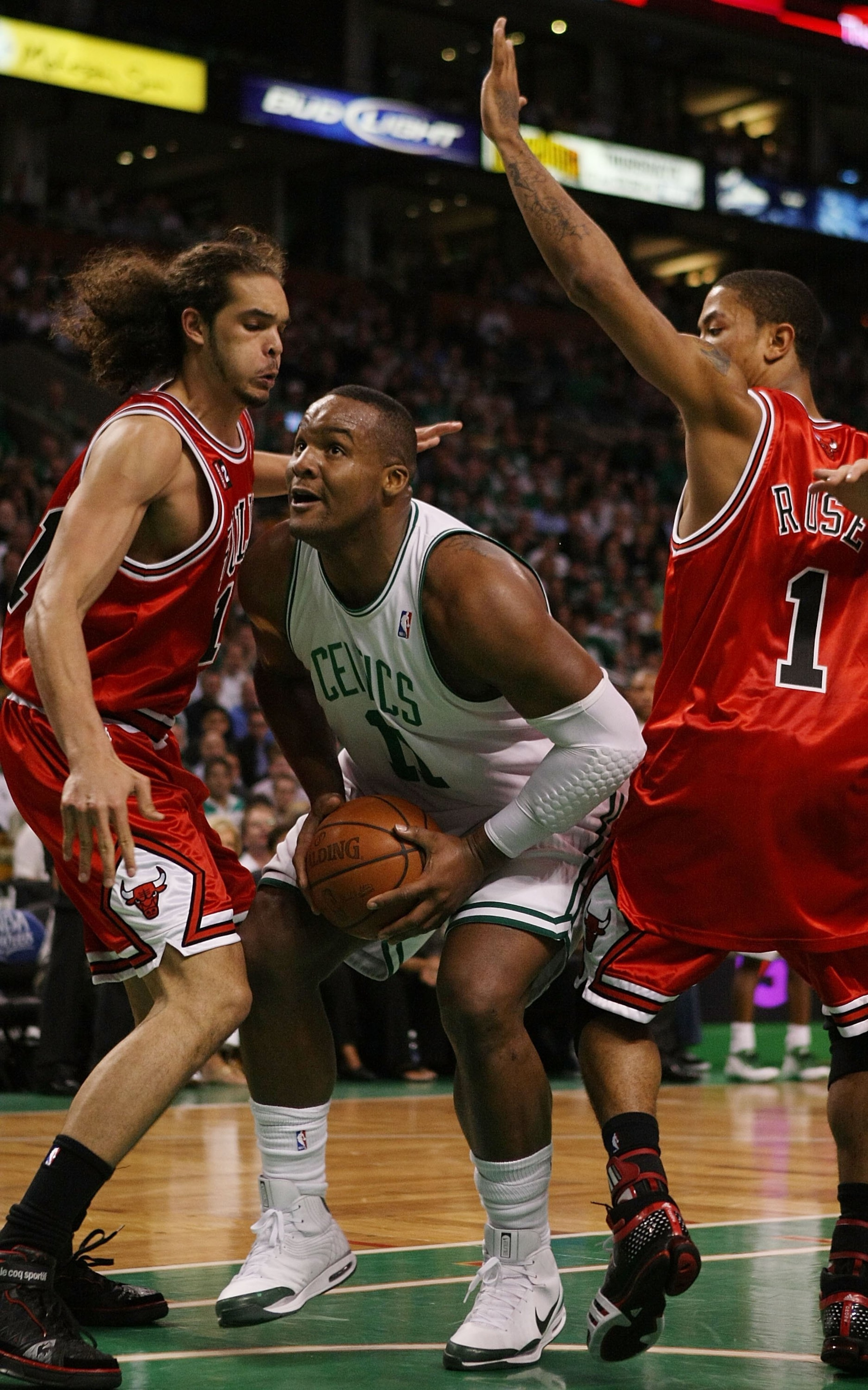 BOSTON - MAY 02:  Glen Davis #11 of the Boston Celtics makes his way through Joakim Noah #13 and Derrick Rose #1 of the Chicago Bulls in Game Seven of the Eastern Conference Quarterfinals during the 2009 NBA Playoffs at TD Banknorth Garden on May 2, 2009